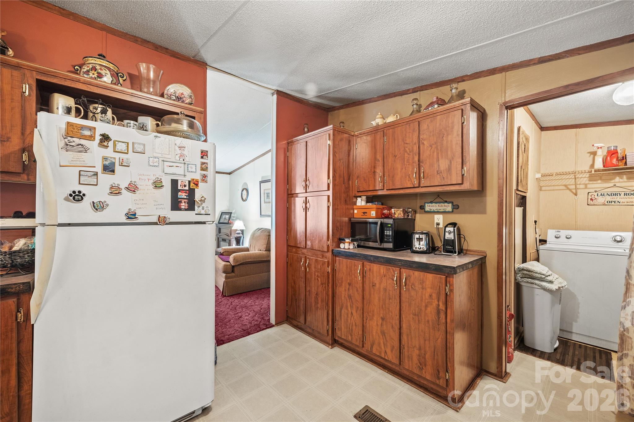 Kitchen opens to the laundry and living room area. - 323 Carlyle Road, Troutman