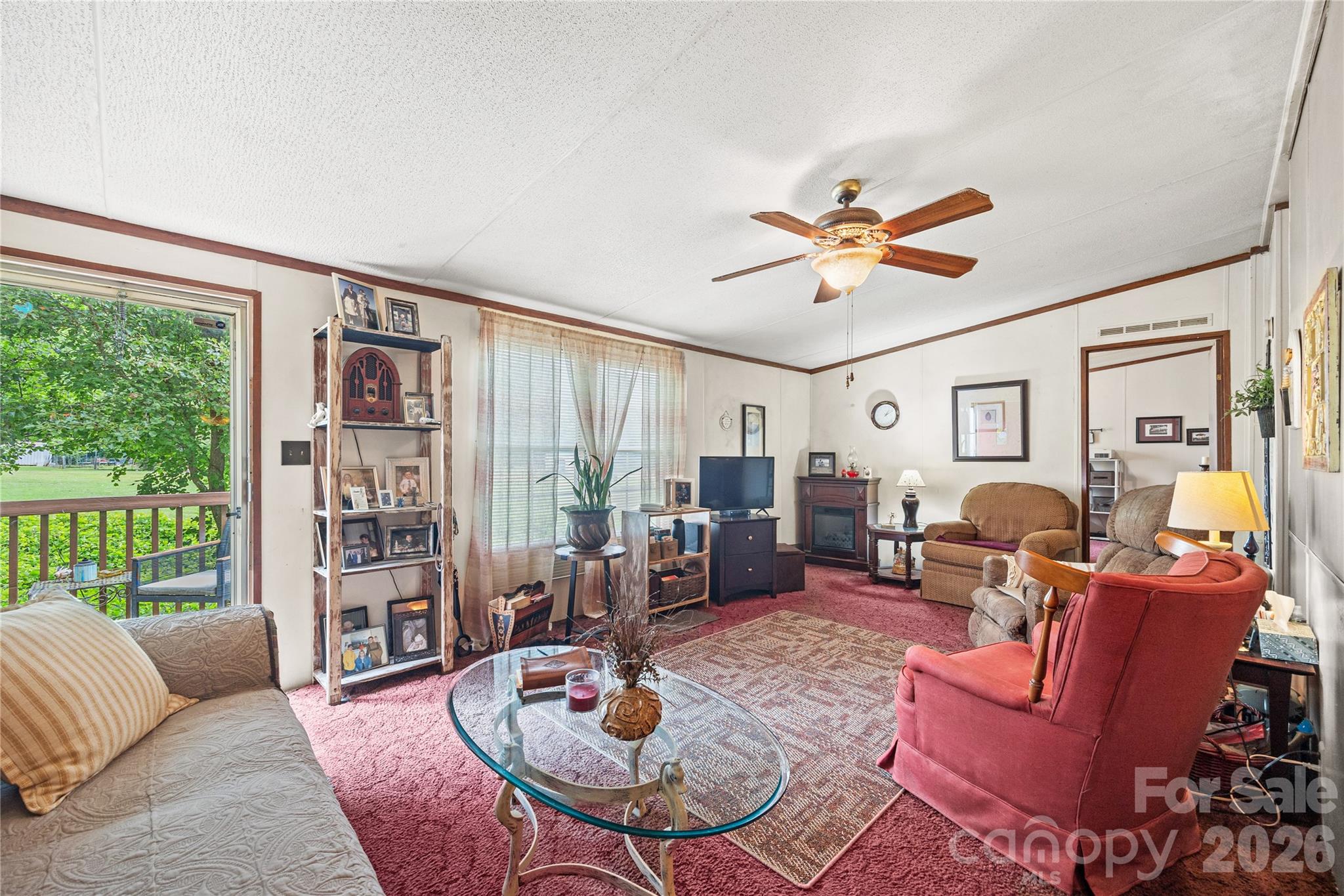 Living room has an electric fireplace that can stay. - 323 Carlyle Road, Troutman