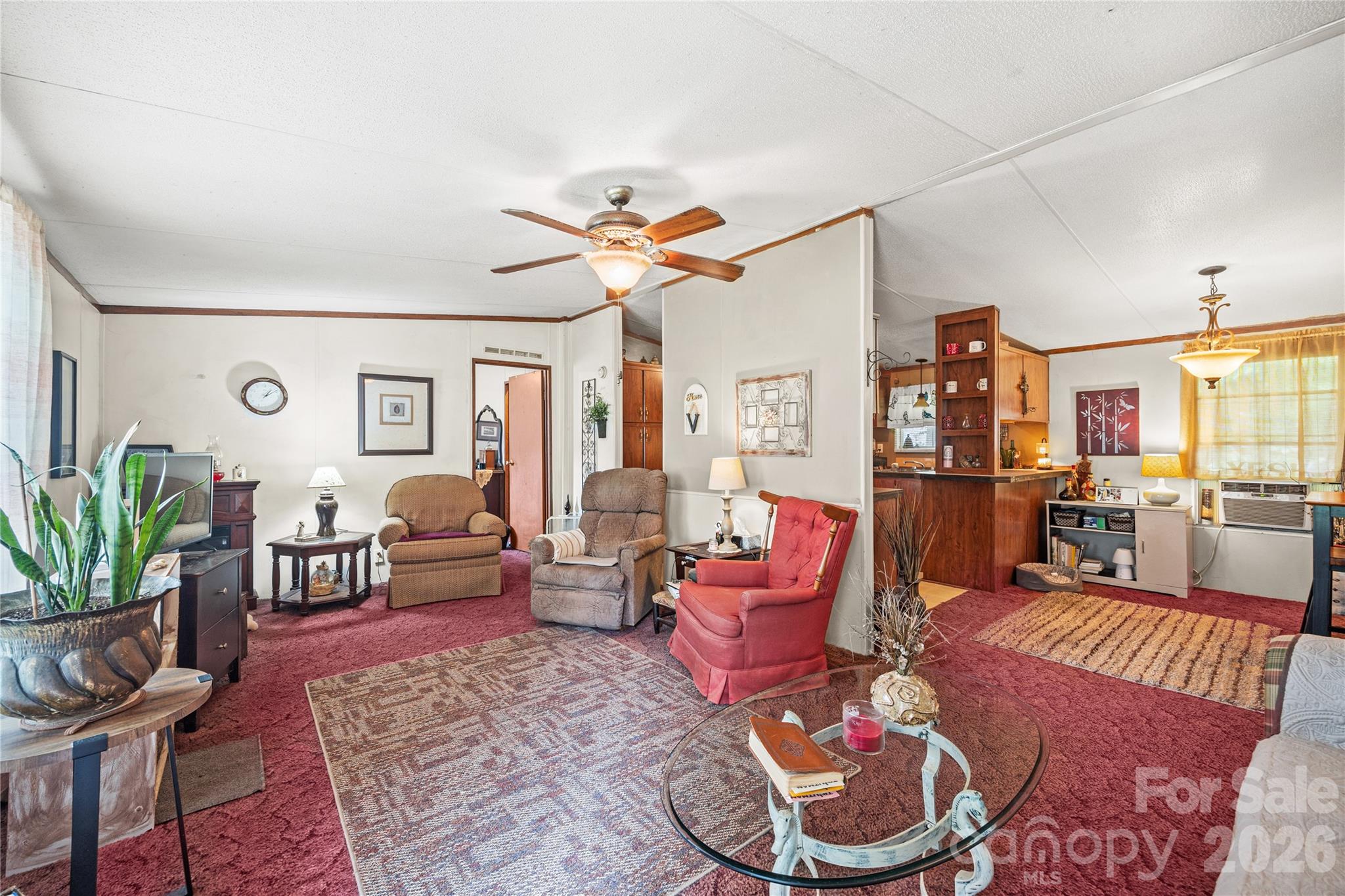 The living room opens up to the kitchen. - 323 Carlyle Road, Troutman