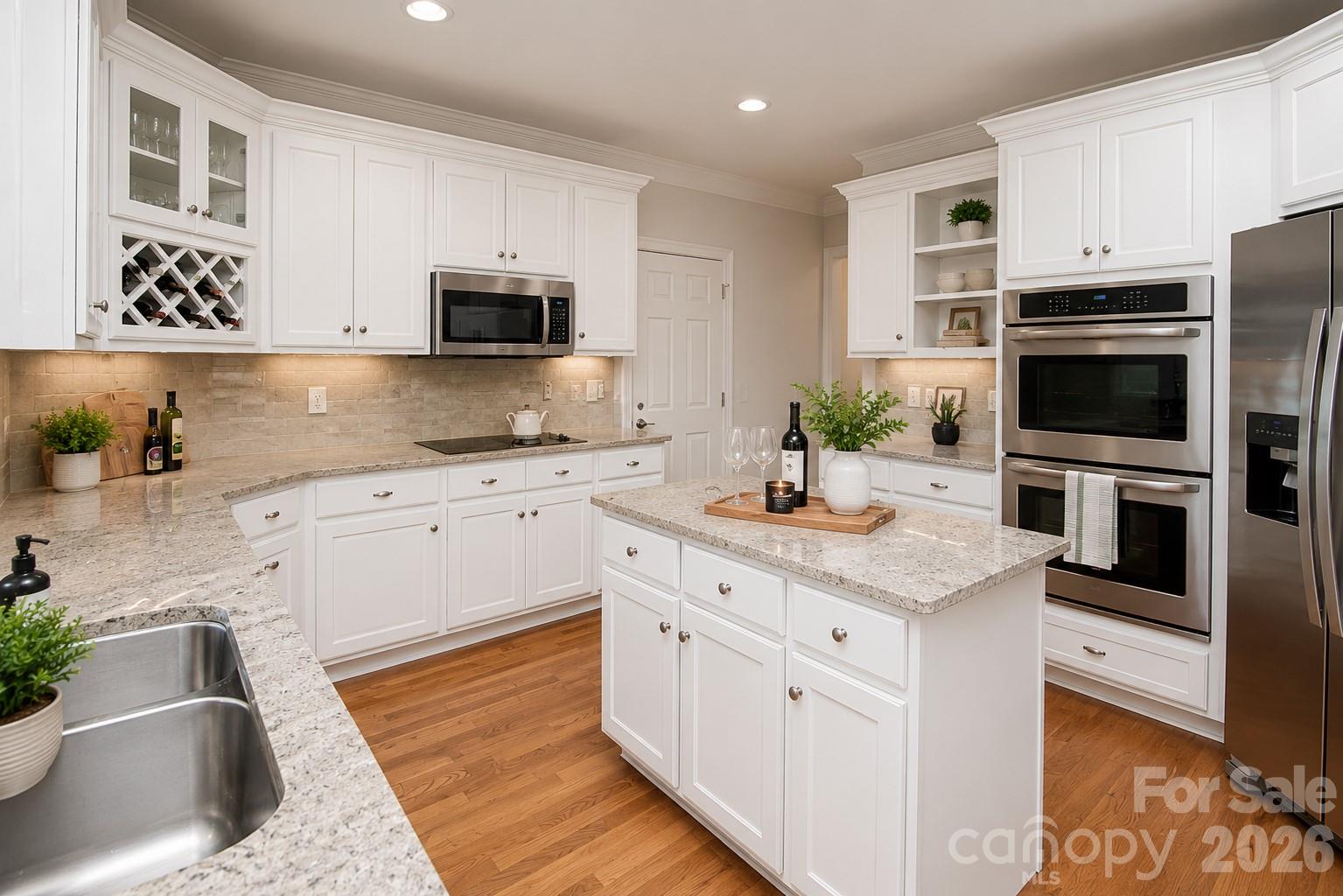 This is an image of what the kitchen would look like if the cabinets were painted white. - 1015 Estate Lane, Matthews