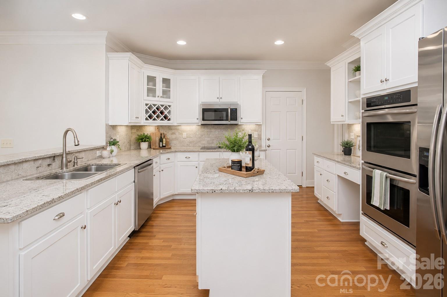 This is an image of what the kitchen would look like if the cabinets were painted white. - 1015 Estate Lane, Matthews