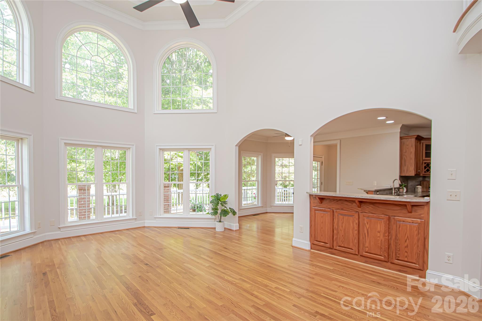 Spacious great room with 2 story ceilings and ceiling fan. - 1015 Estate Lane, Matthews