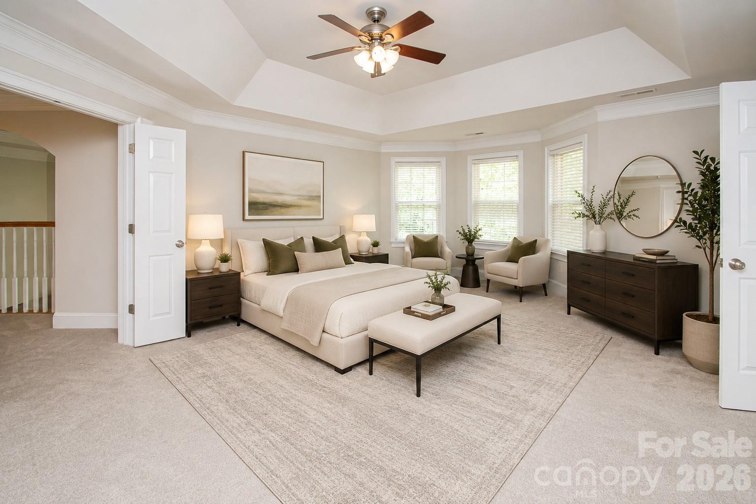 Very spacious primary bedroom with tray ceiling and ceiling fan. - 1015 Estate Lane, Matthews