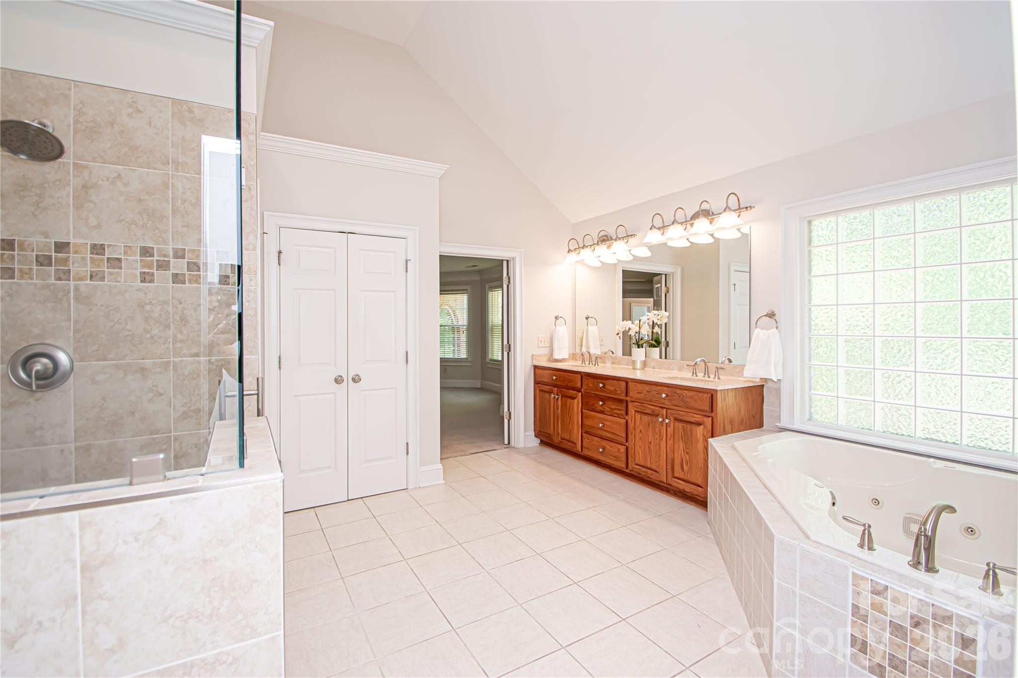 Large primary bathroom with jacuzzi tub and separate shower. - 1015 Estate Lane, Matthews
