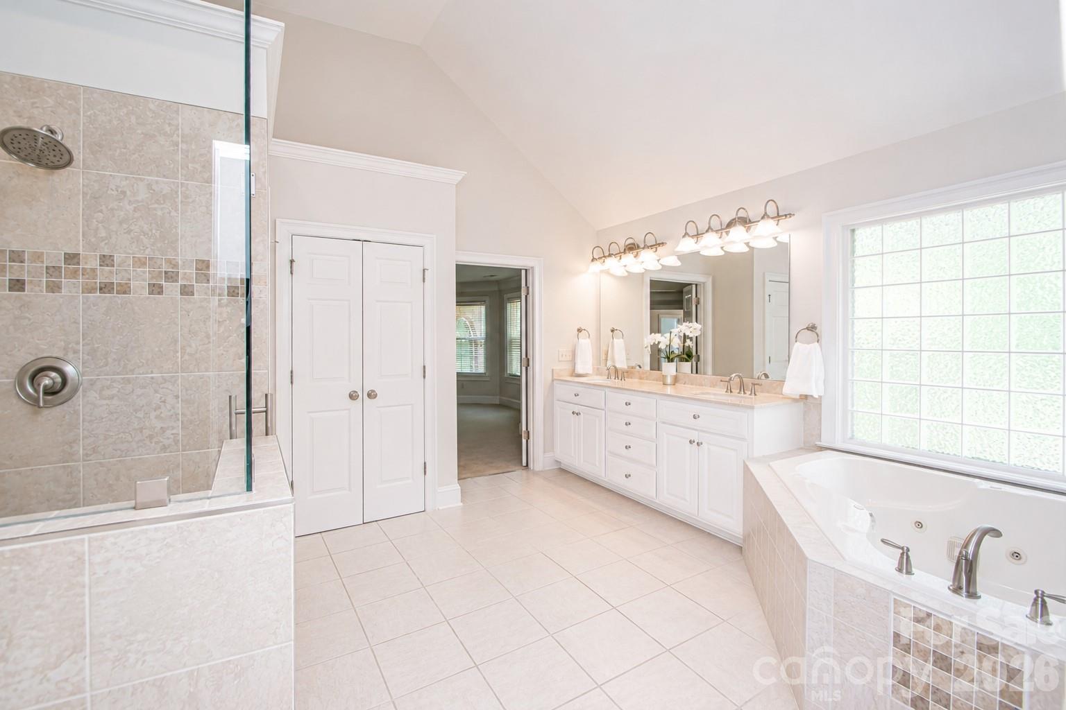 This is an image showing what the primary bathroom would look like if the cabinets were painted white. - 1015 Estate Lane, Matthews