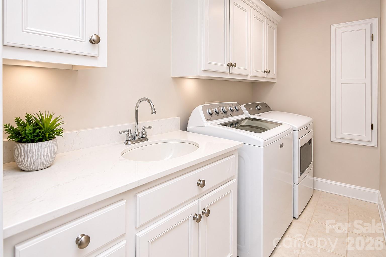 This is an image showing what the laundry room would look like if the cabinets were painted white. - 1015 Estate Lane, Matthews