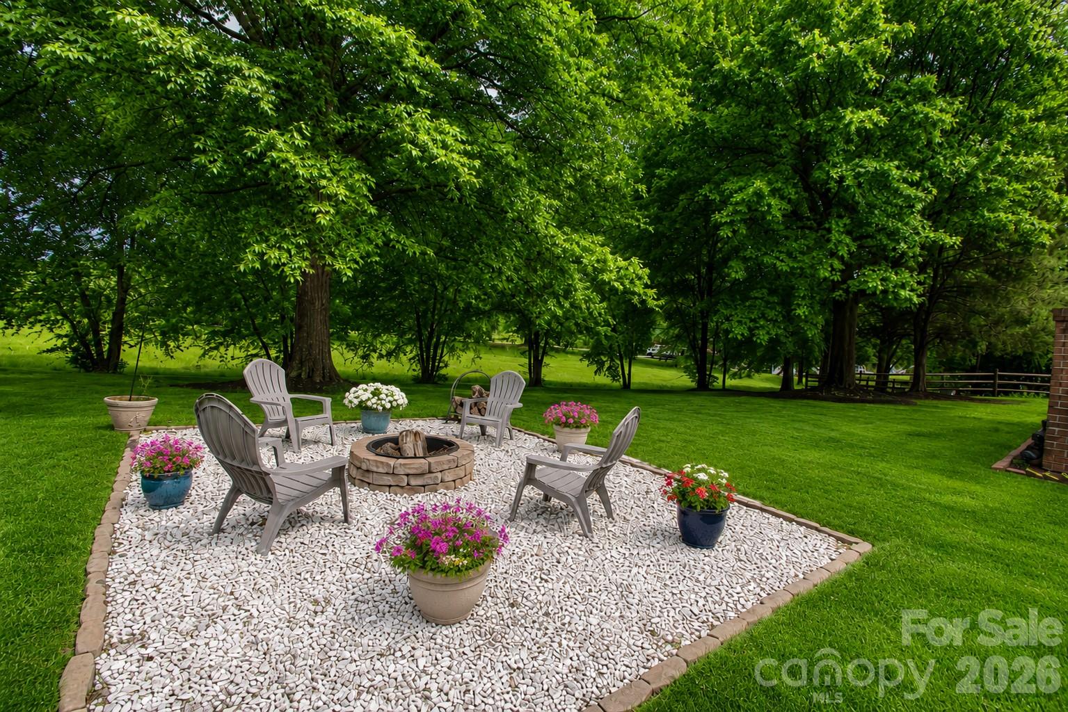 Fire pit in the backyard perfect for entertaining. Grass was enhanced with AI. It shows what it could look like. - 1015 Estate Lane, Matthews