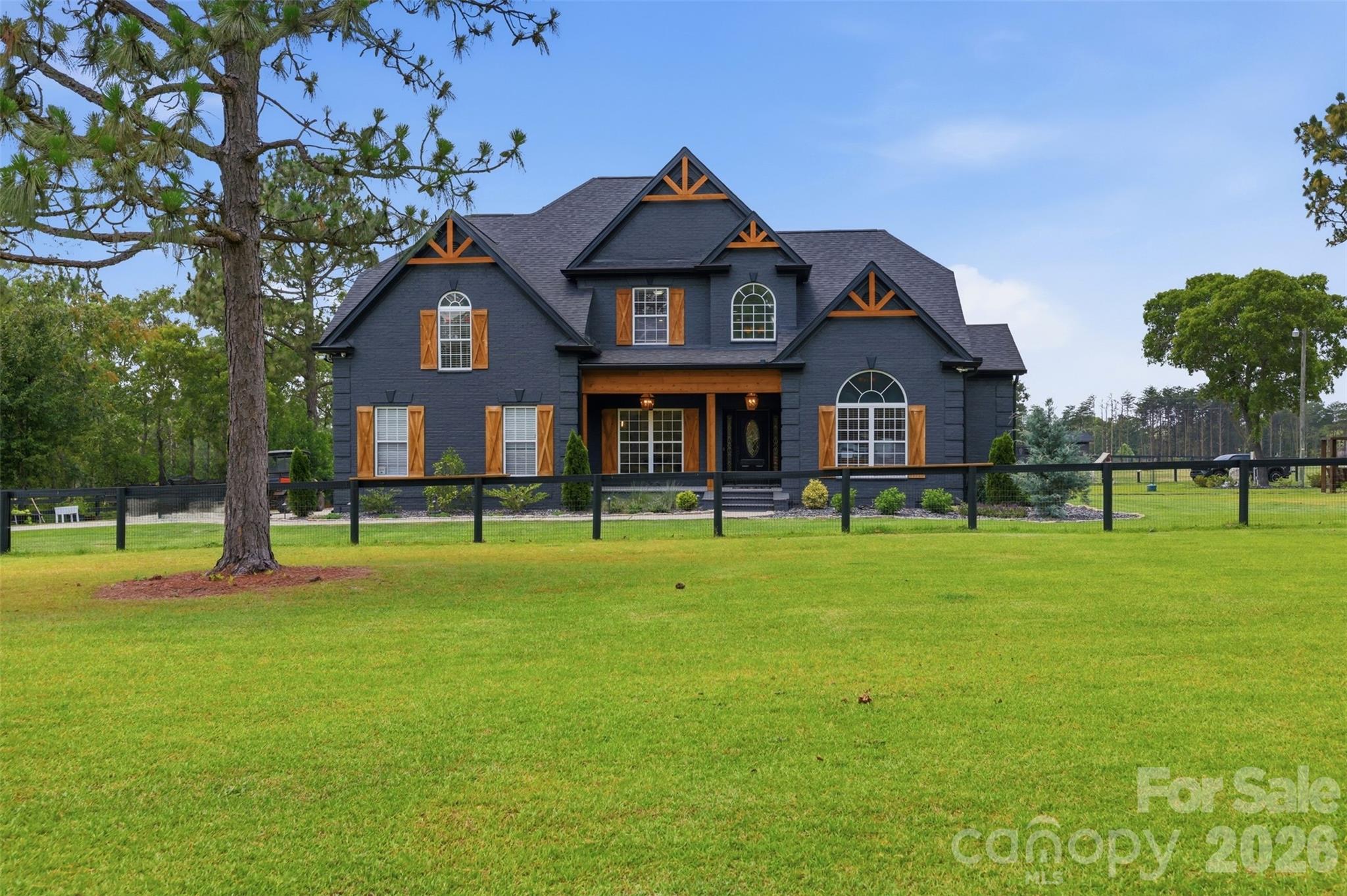 Custom residence is perfectly positioned to overlook the surrounding pastures and grounds. - 8520 Stock Horse Trail, Windsor