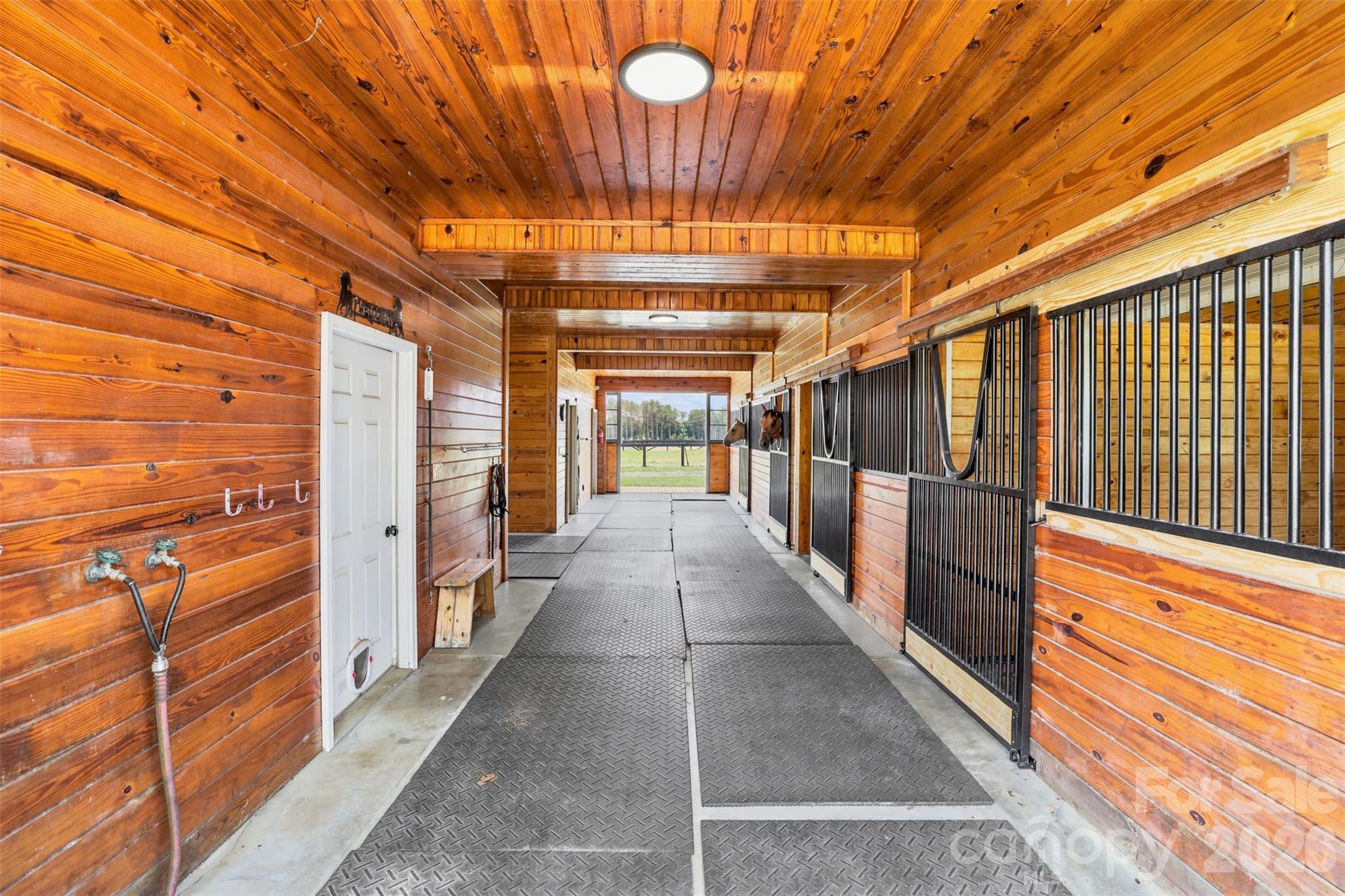 Thoughtfully designed barn exterior offers easy access to paddocks, pastures, and equestrian amenities. - 8520 Stock Horse Trail, Windsor