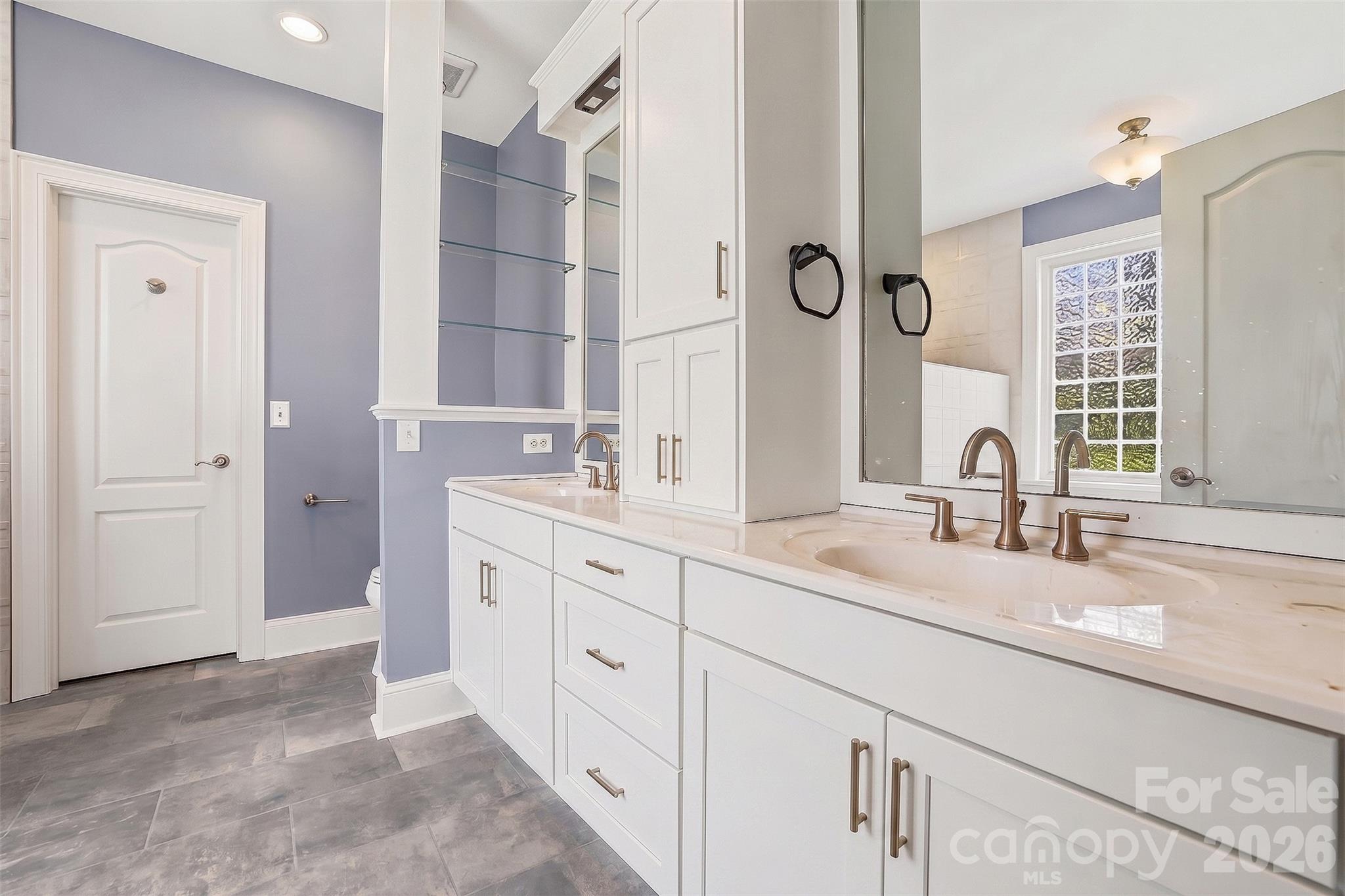 Spacious dual-vanity bath combines style, function, and abundant storage. - 8520 Stock Horse Trail, Windsor