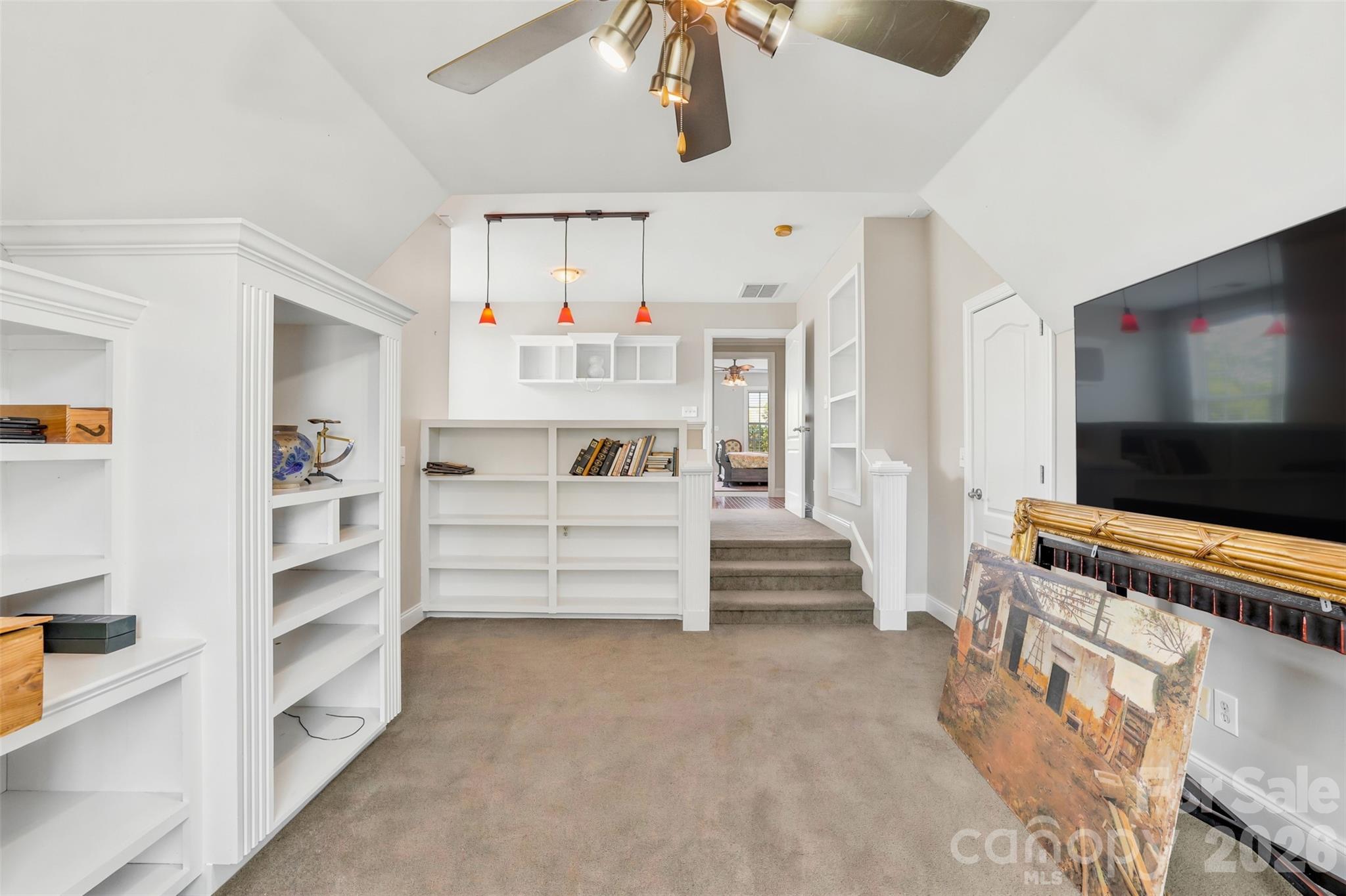 Grand foyer showcases hardwood floors, soaring ceilings, and a striking staircase. - 8520 Stock Horse Trail, Windsor