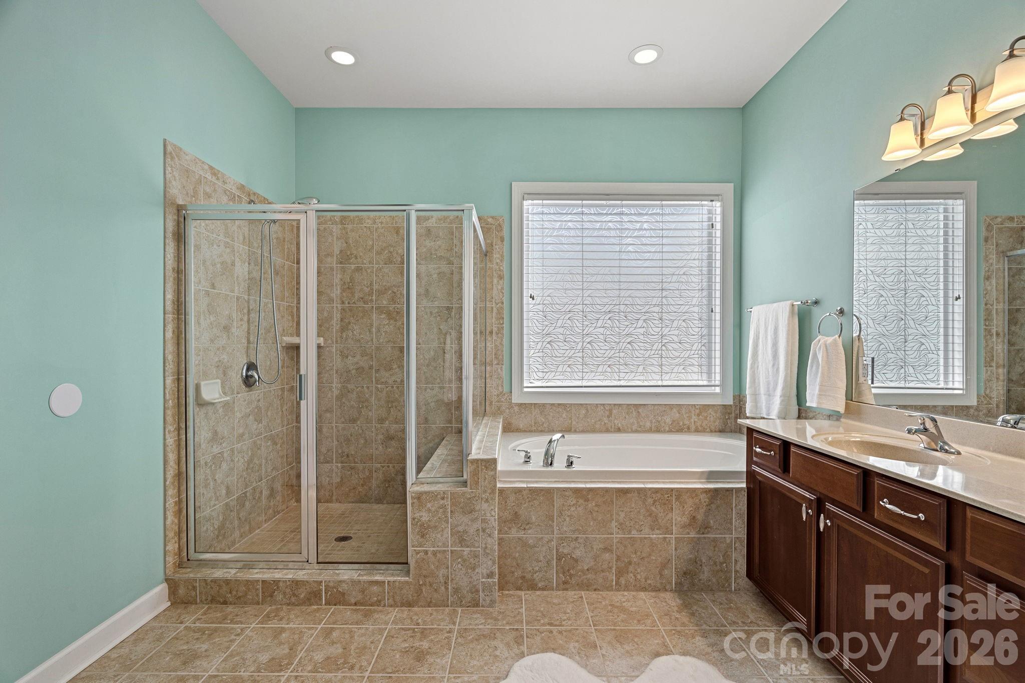 Primary bath with soaking tub and separate shower - 10654 Rippling Stream Drive NW, Concord