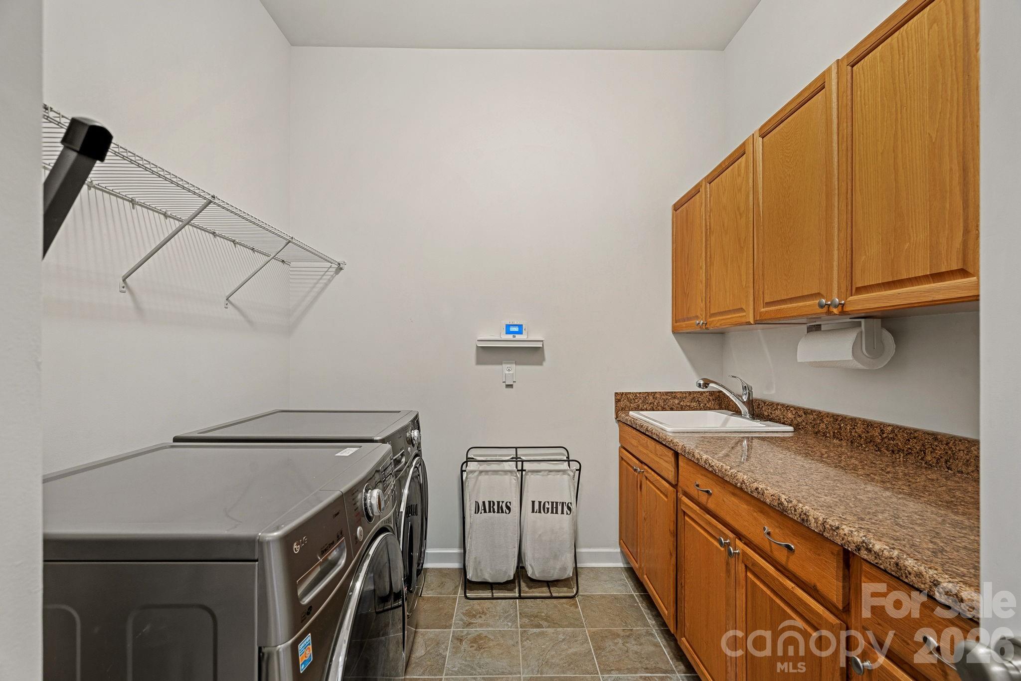 Large Laundry Room with sink - 10654 Rippling Stream Drive NW, Concord