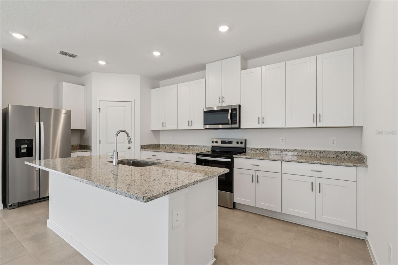 Photo is not of the actual home, but is an inspirational photo of builder’s model home and may depict options, furnishings, and/or decorator features that are not included. - 78 WANDERING CREEK WAY, PALM COAST