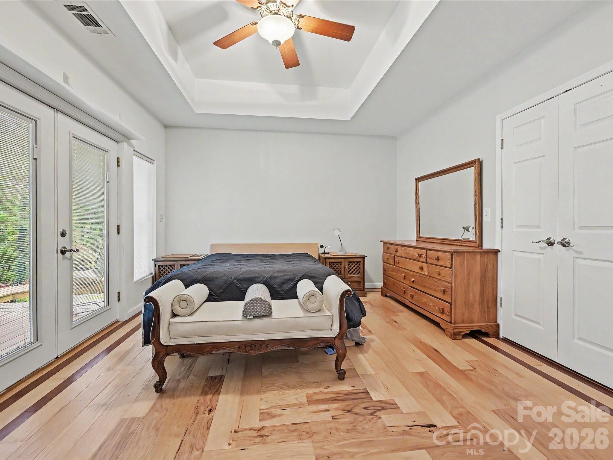 Basement bedroom with ceiling fan, exterior access, custom hardwood floors - 152 Lighthouse Road, Mount Holly