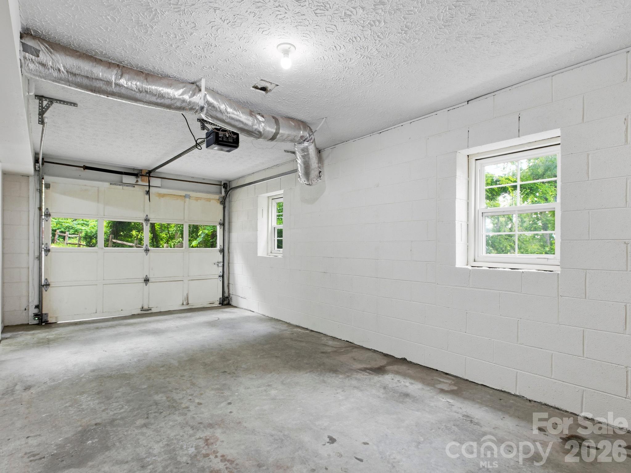 Single car garage with direct access to partially  finished basement - 44 Leisure Mountain Road, Asheville