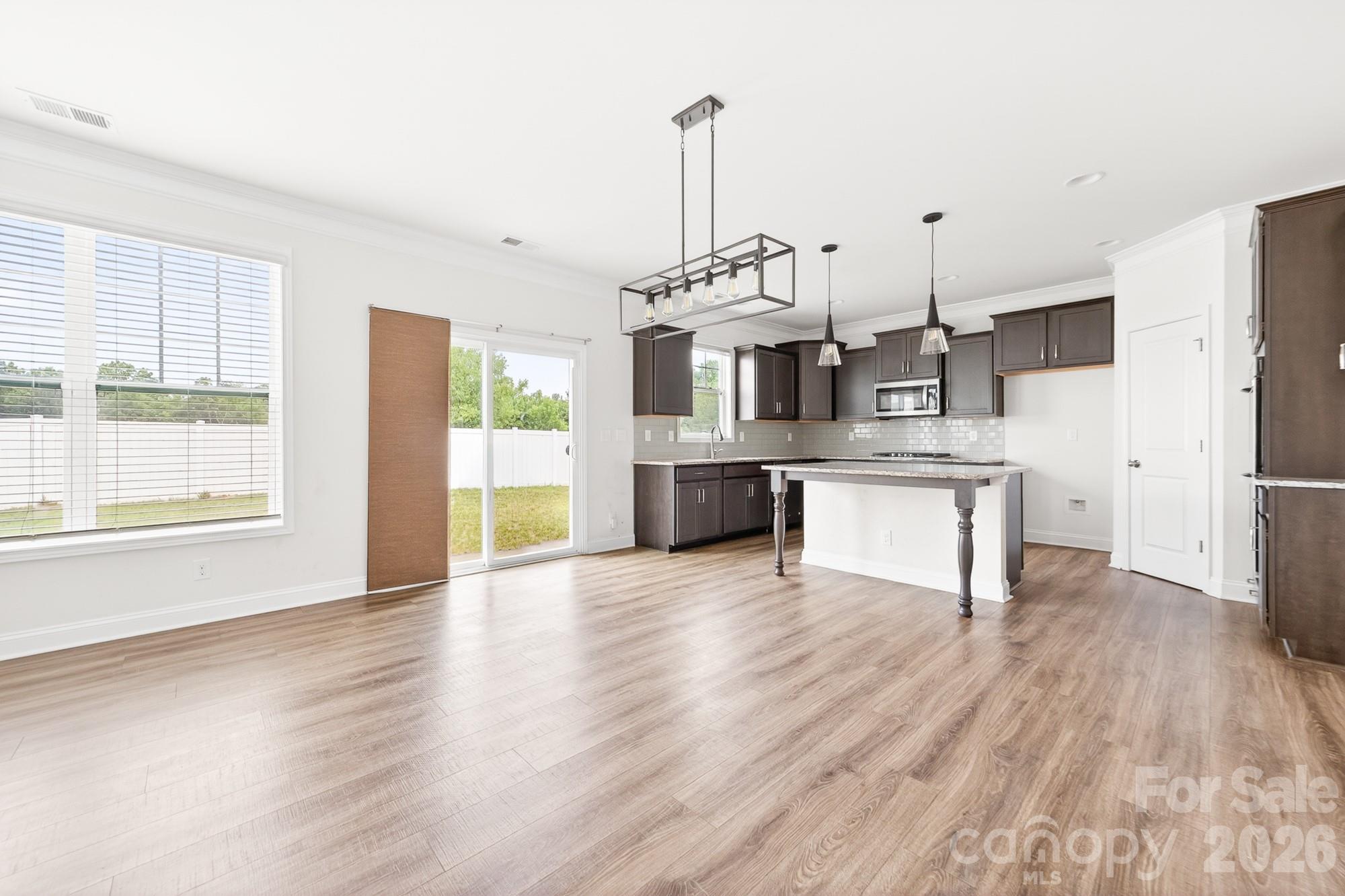 There is a dining area space between the island bar and the den area. Right in front of the sliding doors leading to the backyard - 5972 Redwood Pine Road, Concord