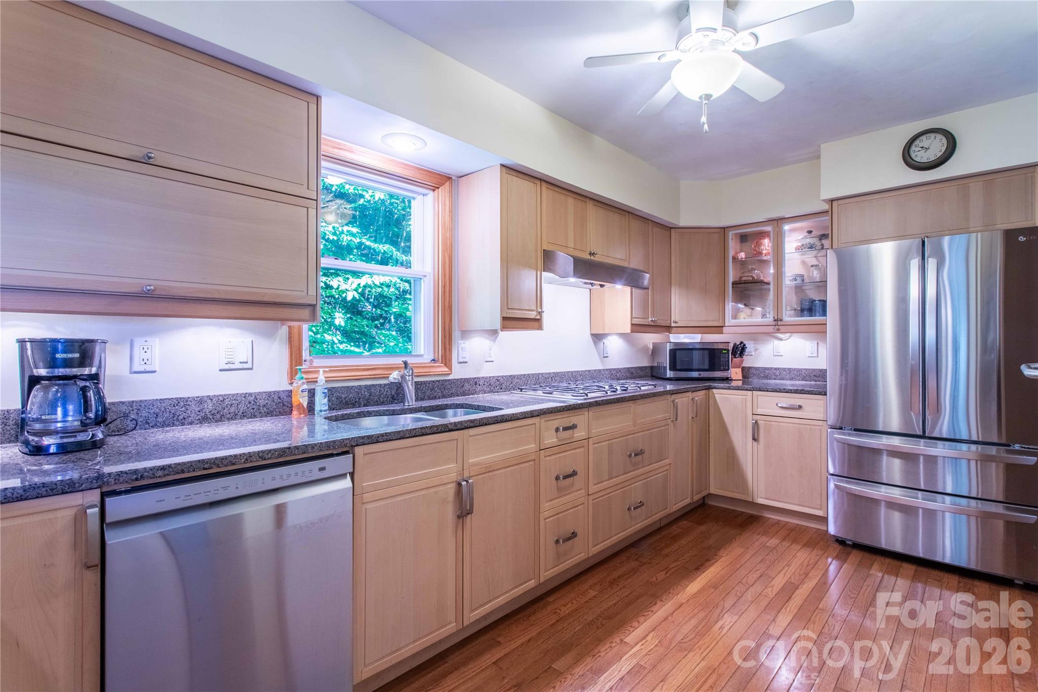 Plenty of cabinets in this kitchen. Note the gleaming wood floors. - 22 Great Aspen Way, Black Mountain