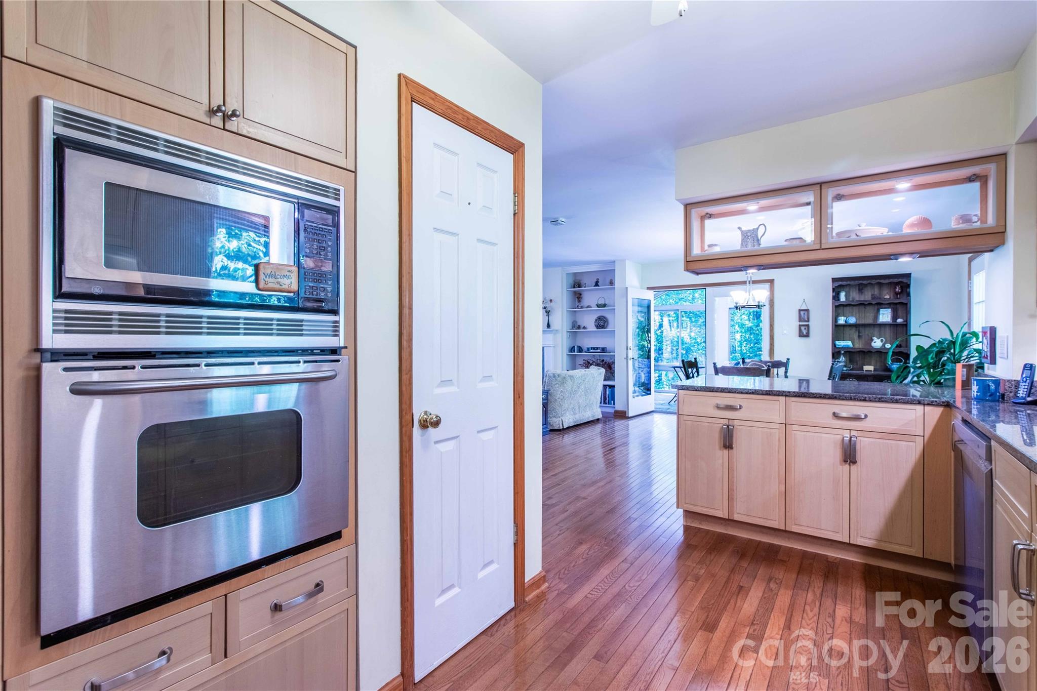 Pantry in kitchen holds all your packaged and canned groceries as well as small appliances. Note the granite counters and wall oven. Also another look at the lighted, overhead display cabinets. - 22 Great Aspen Way, Black Mountain