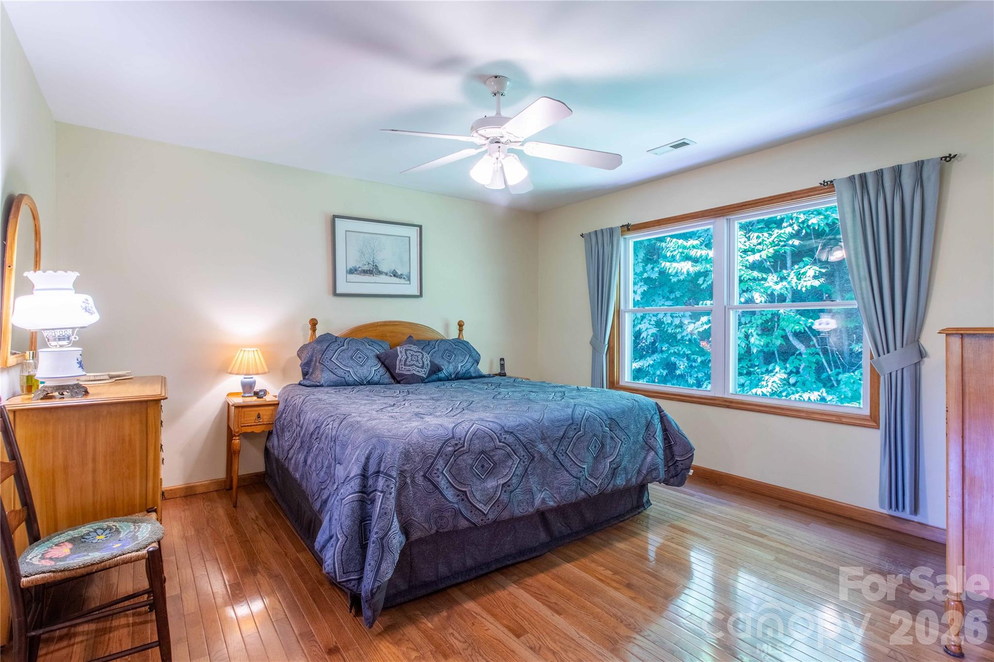 Primary bedroom offers plenty of space for a king-size bed. Note the gleaming wood floors. - 22 Great Aspen Way, Black Mountain