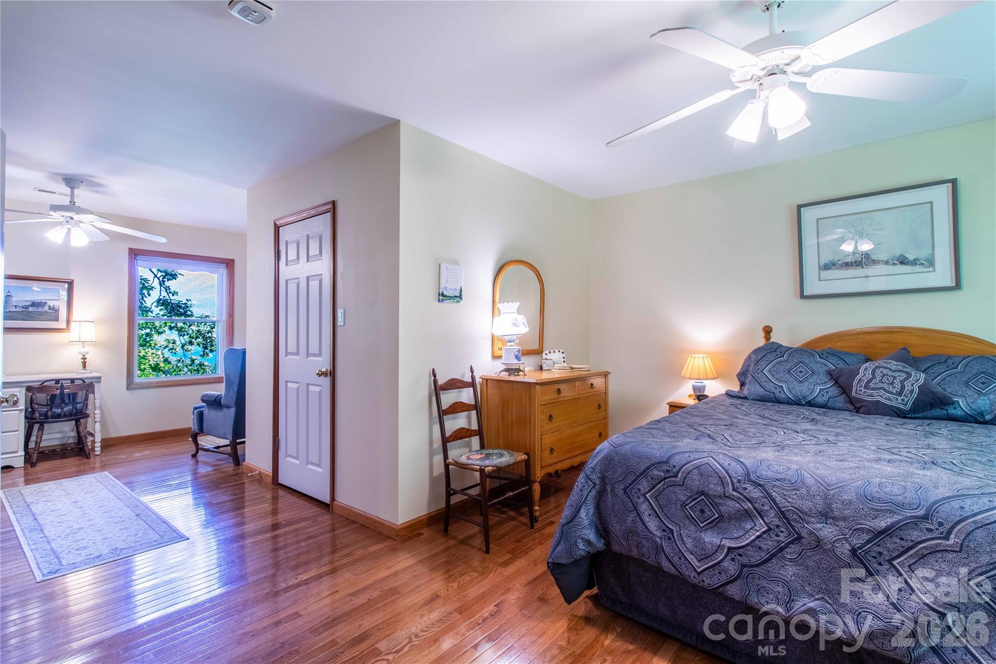 Sitting area off the primary bedroom offers a beautiful, year-round mountain view while reading a book. Could also be used for a home office with a year-round view. - 22 Great Aspen Way, Black Mountain