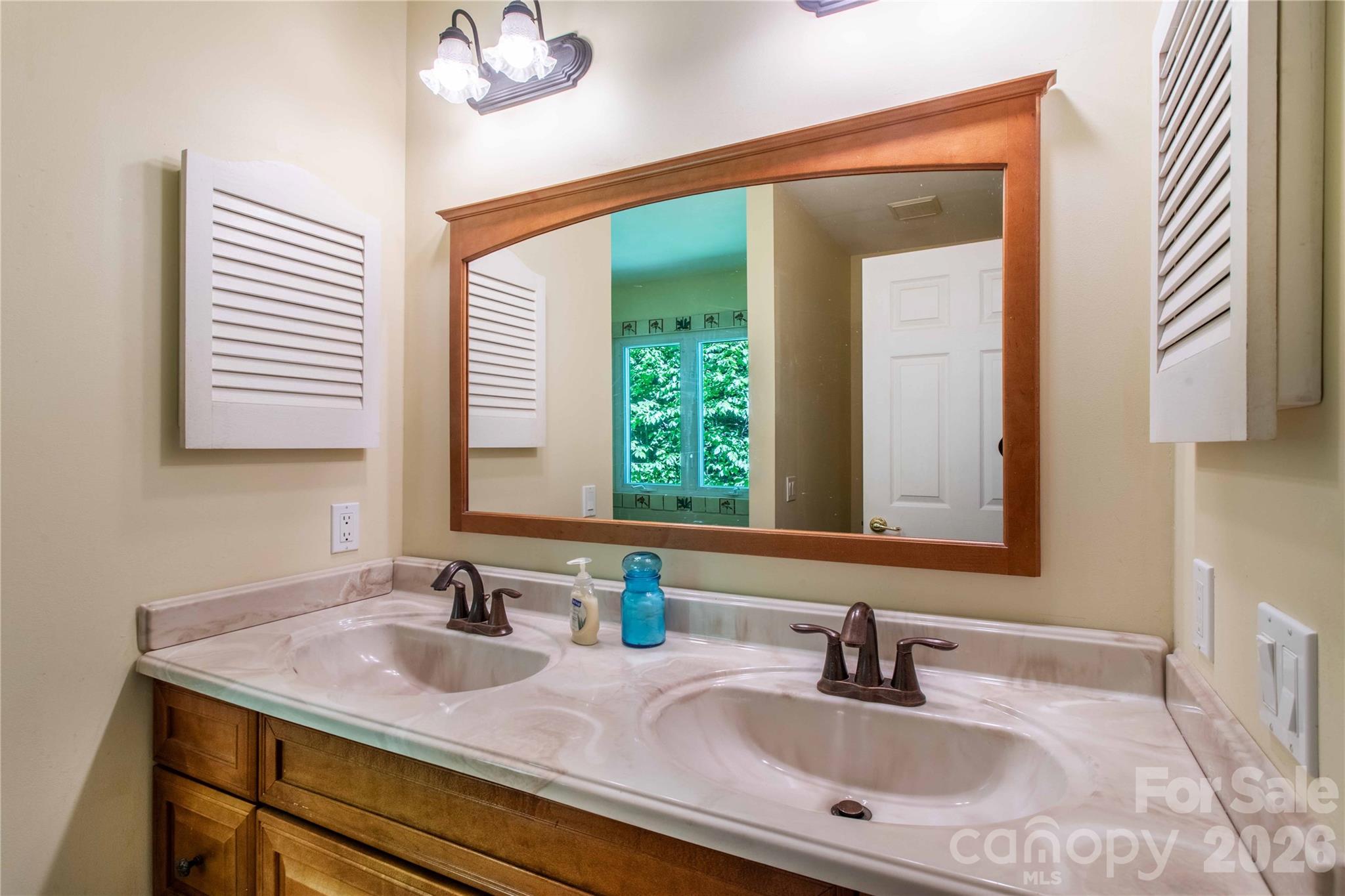 Twin vanities in the primary bath. - 22 Great Aspen Way, Black Mountain