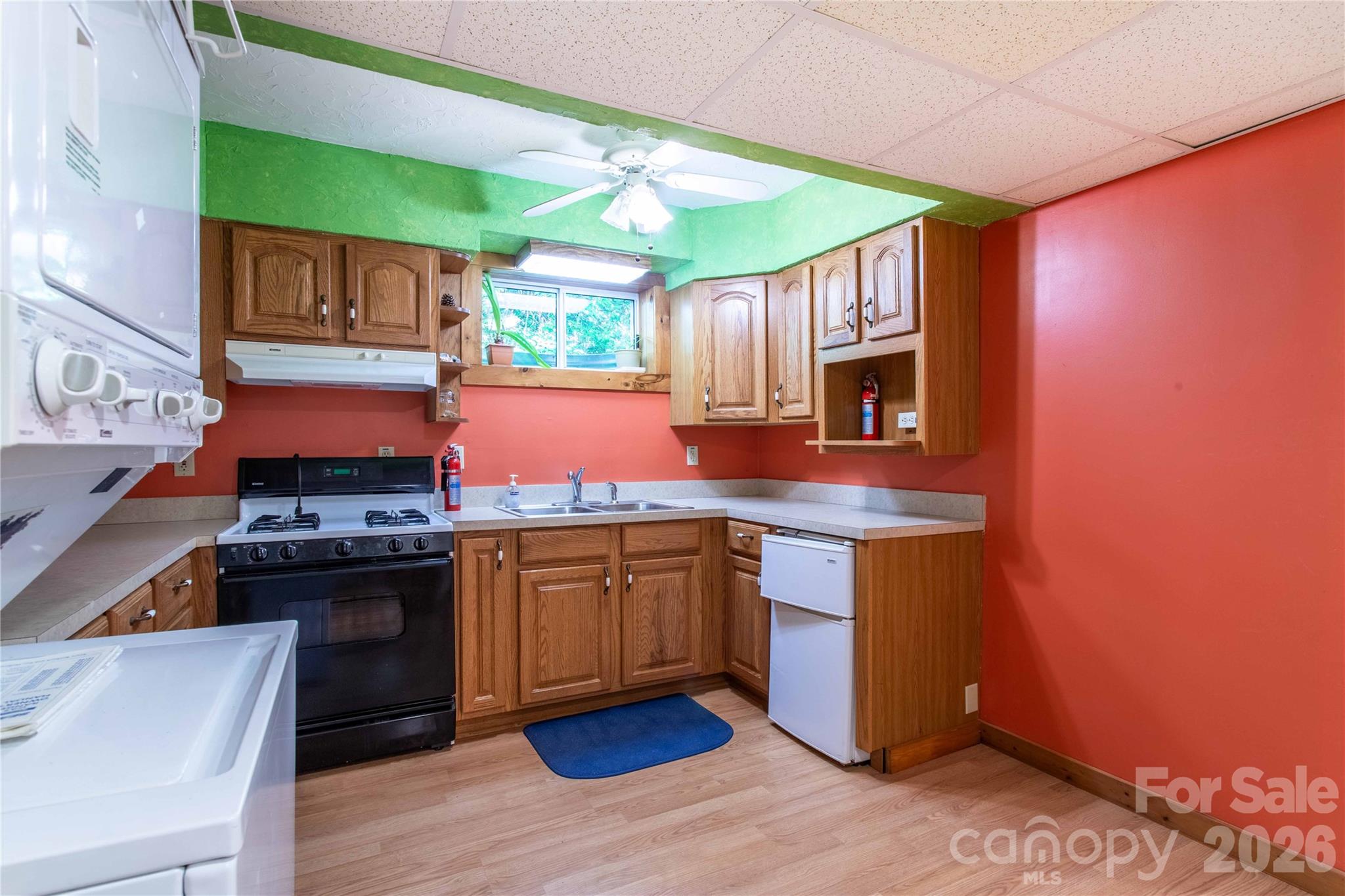 Lower level kitchenette features never used stacked washer and dryer. There is also space for a snack bar on the right. - 22 Great Aspen Way, Black Mountain