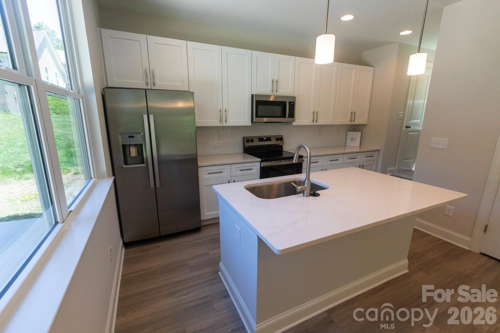 Breakfast bar with Pendant lights over island add style - 209 James Street, Kannapolis