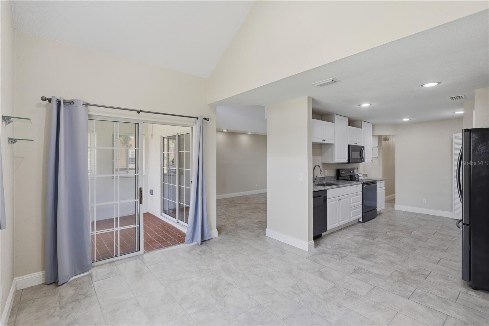 Breakfast area leading to the screened porch - 44 CAPTAINS WALK, PALM COAST