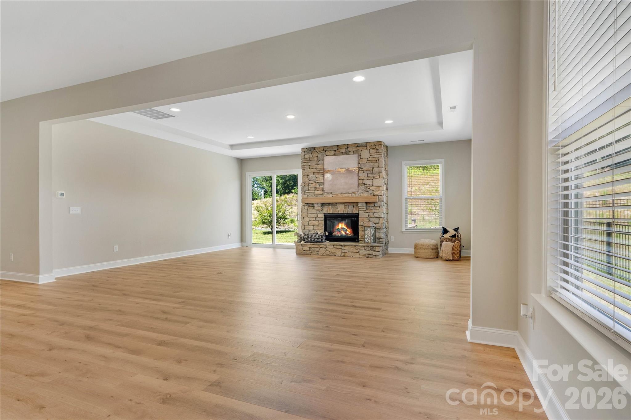 Enjoy the Floor to Ceiling Stone Gas Fireplace with Mantle (Virtually Staged Fire) - 8091 Woodline Lane, Denver