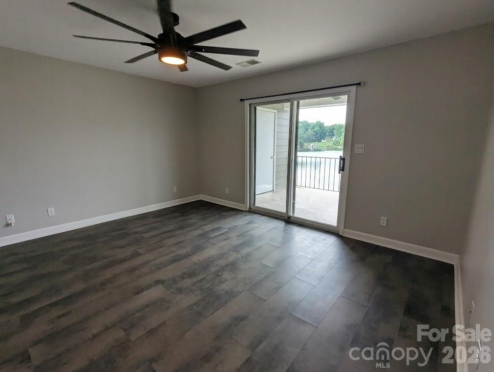 Primary bedroom overlooking the waterfront. New lighting and ceiling fan. - 100 Northshore Court, Cherryville