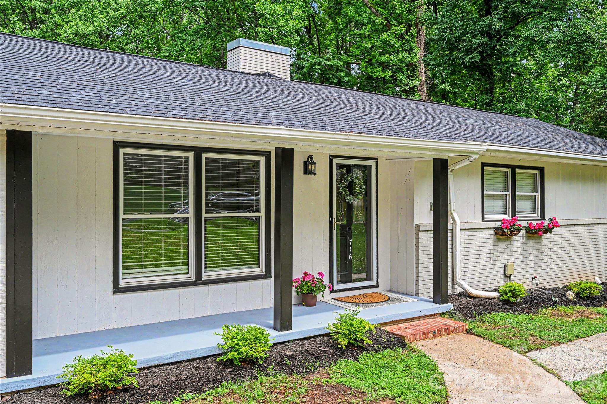 Inviting covered front porch with updated landscaping and classic curb appeal. - 716 Grandview Drive NE, Concord