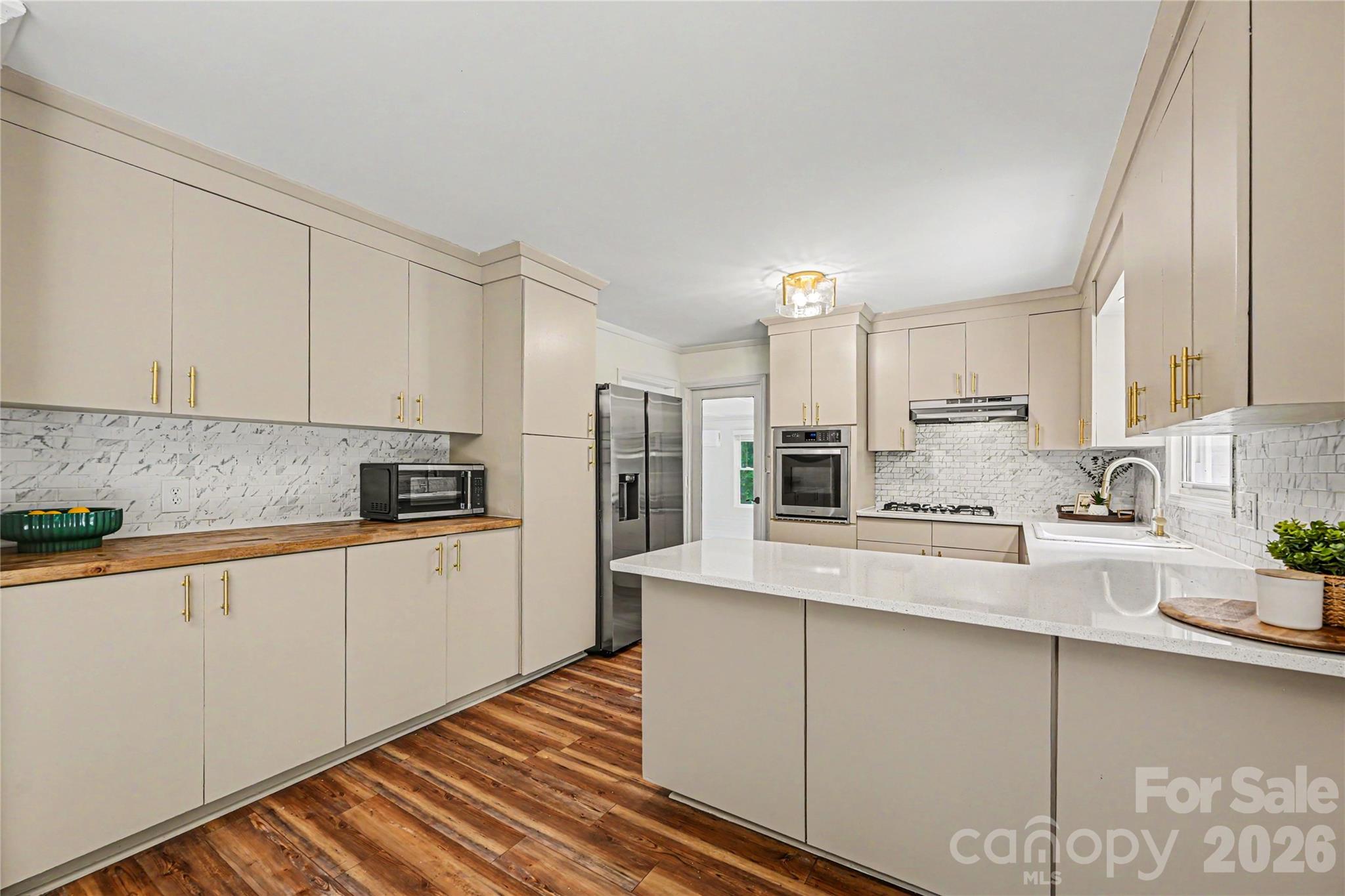 Dedicated butcher block workspace and extensive pantry style storage keep everything within reach. - 716 Grandview Drive NE, Concord
