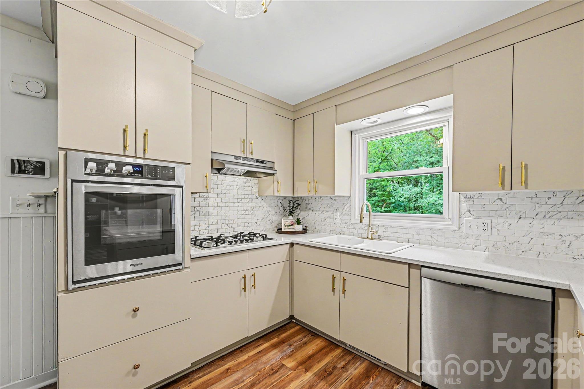 Thoughtfully updated kitchen with generous prep space, ample storage, and views of the private backyard. - 716 Grandview Drive NE, Concord