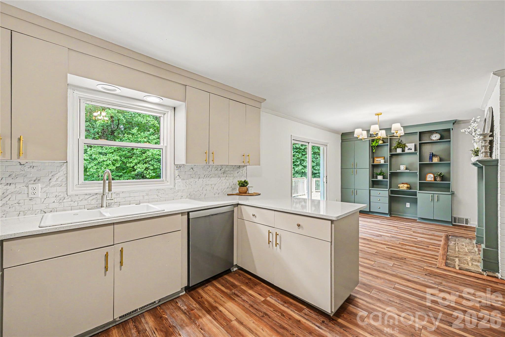 Open concept kitchen and dining area with direct access to the oversized deck, perfect for everyday living and entertaining. - 716 Grandview Drive NE, Concord