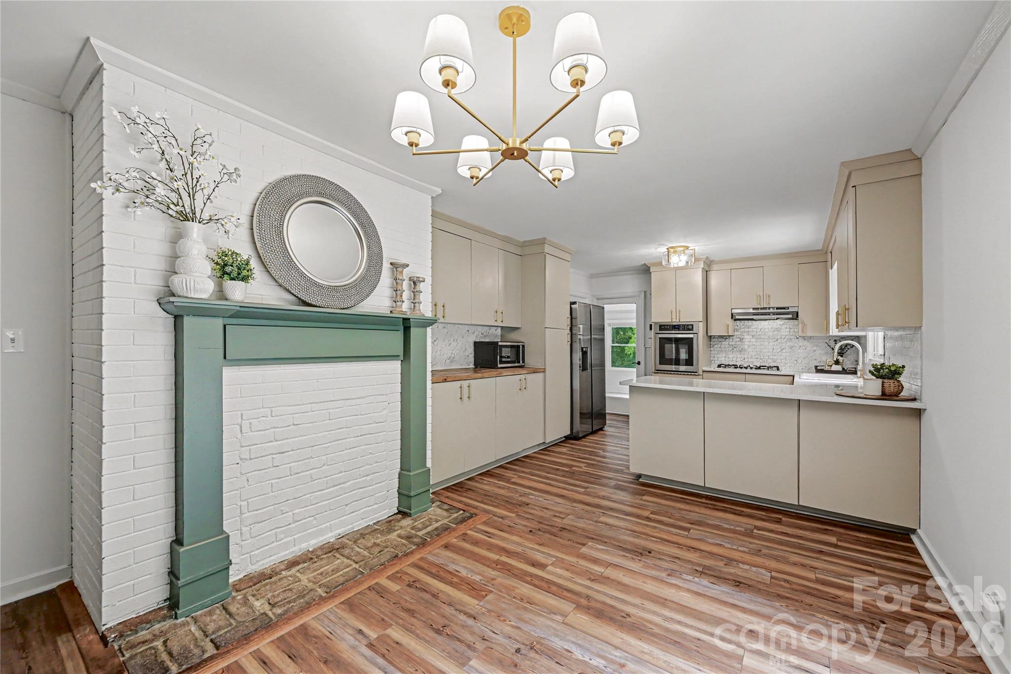 Open dining and kitchen layout creates an ideal space for entertaining, gathering, and everyday living. - 716 Grandview Drive NE, Concord