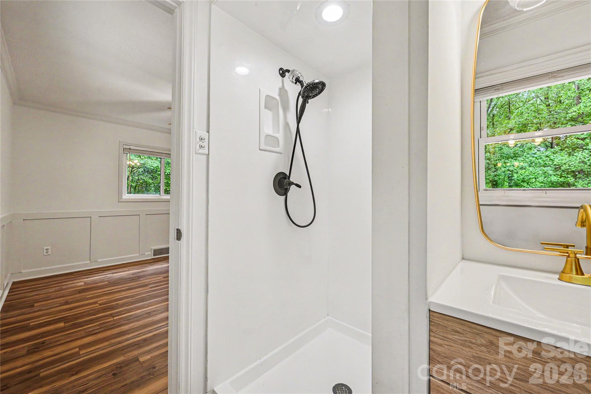 Updated primary bath featuring a walk in shower and modern fixtures. - 716 Grandview Drive NE, Concord