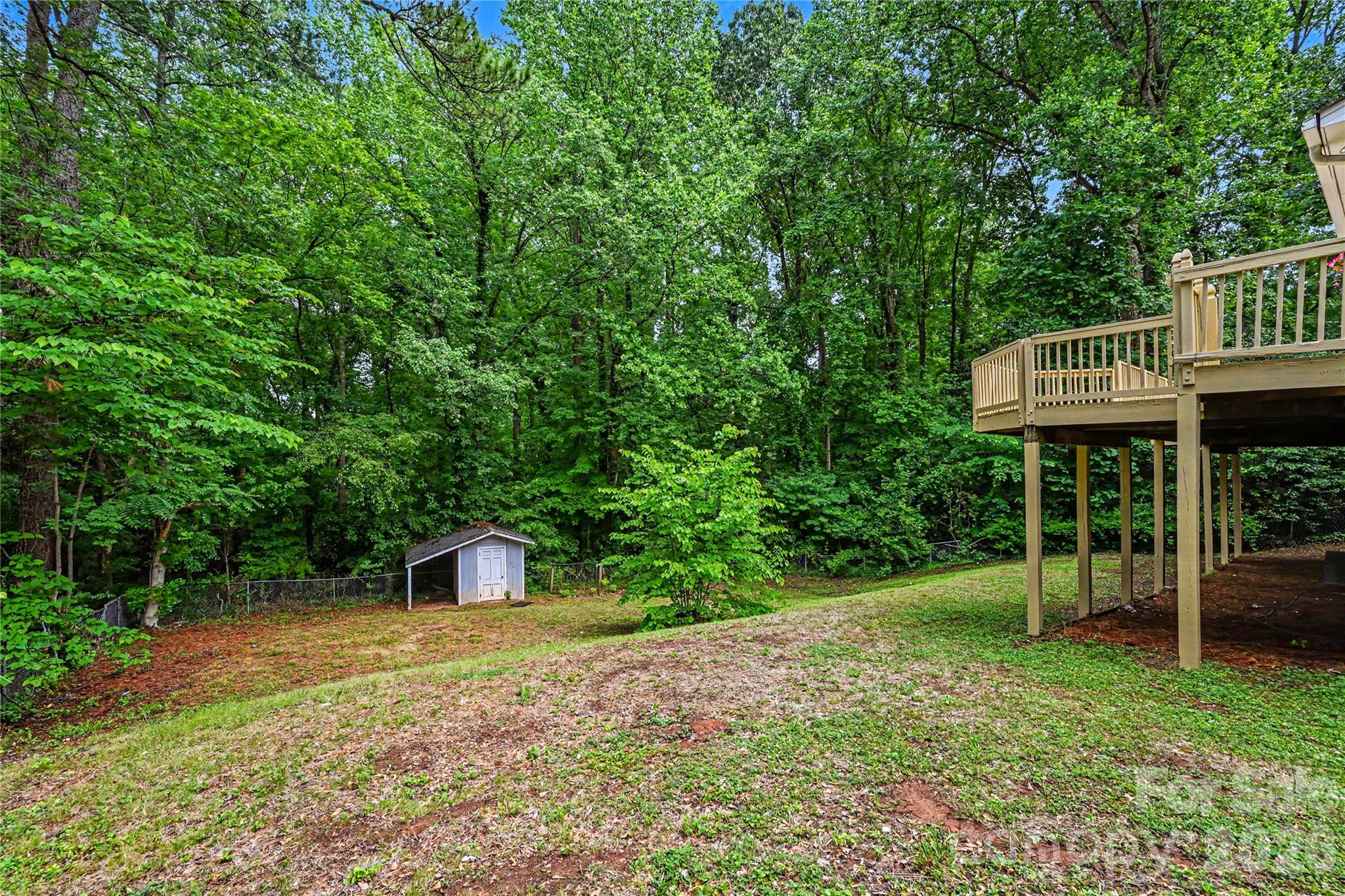 Enjoy the perfect balance of open yard space and wooded privacy on this spacious half acre lot. - 716 Grandview Drive NE, Concord