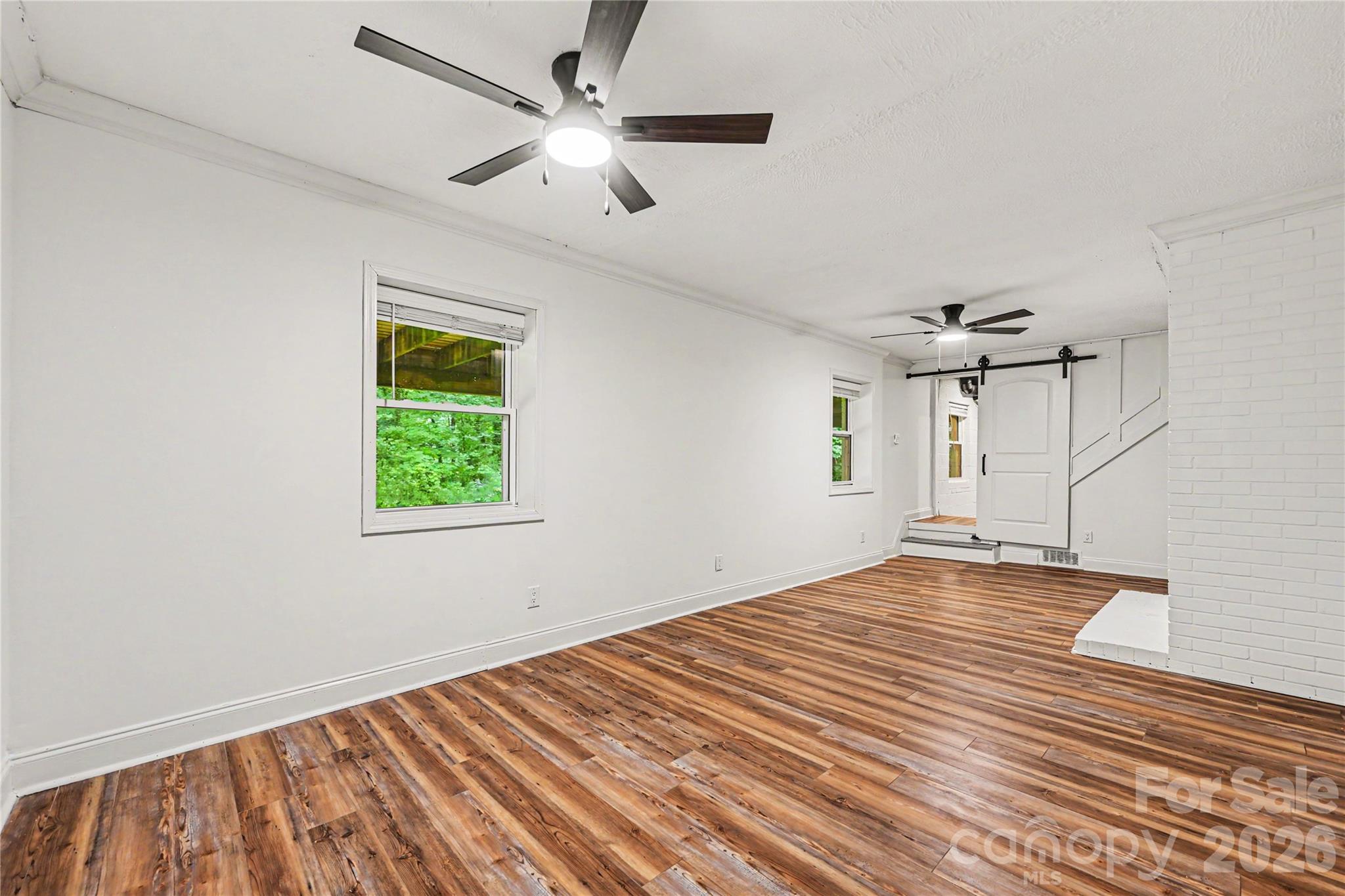 Expansive 312 square foot heated lower level space offering flexibility for work, play, hobbies, fitness, or additional living needs. - 716 Grandview Drive NE, Concord