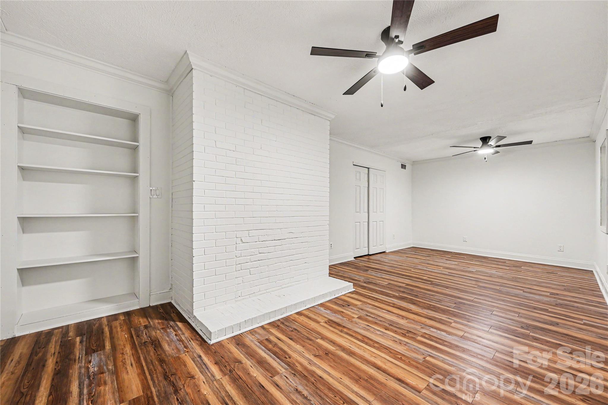 Spacious lower level flex room featuring a closet, built in shelving, and endless possibilities for a home office, recreation room, media space, or guest retreat. - 716 Grandview Drive NE, Concord