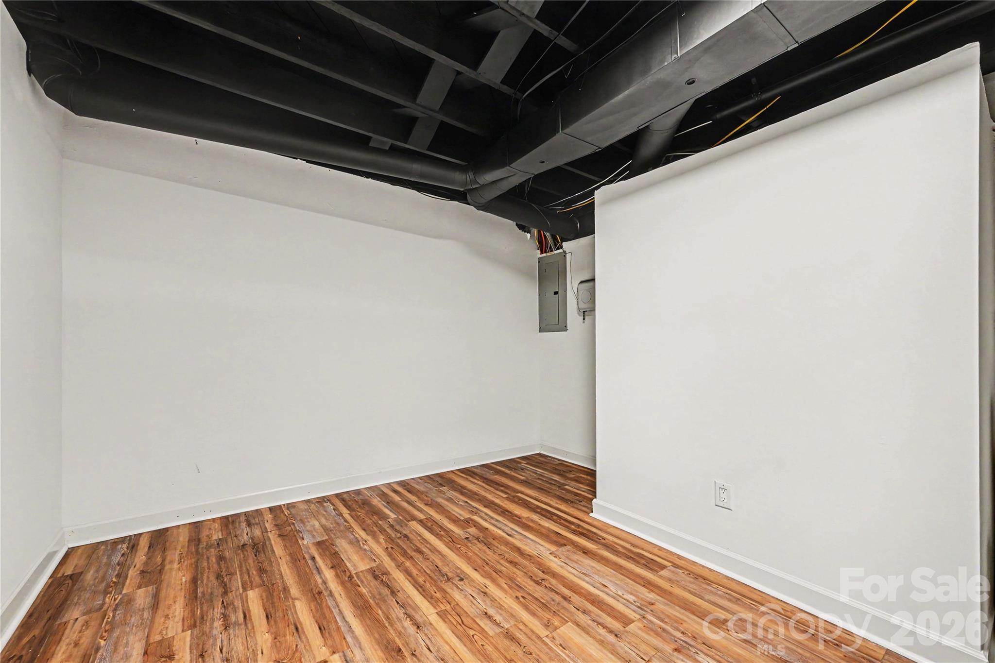 Private lower level flex room perfect for a home office, gym, hobby room, craft space, or additional recreation area. - 716 Grandview Drive NE, Concord