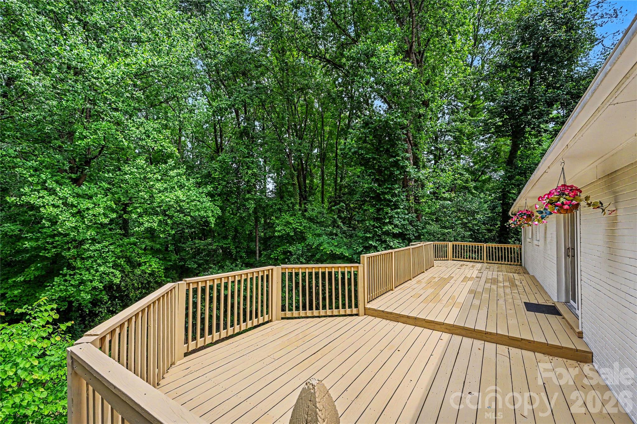 Enjoy peaceful wooded views from this oversized deck designed for gathering with family and friends. - 716 Grandview Drive NE, Concord