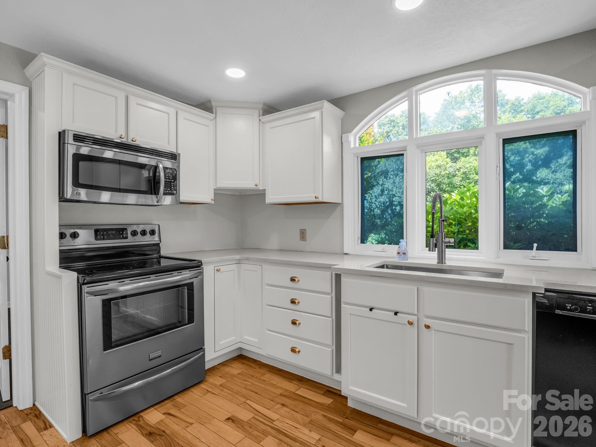 Kitchen facing oven, Laundry Room to the left - 35 Chastain Hill Road, Mills River