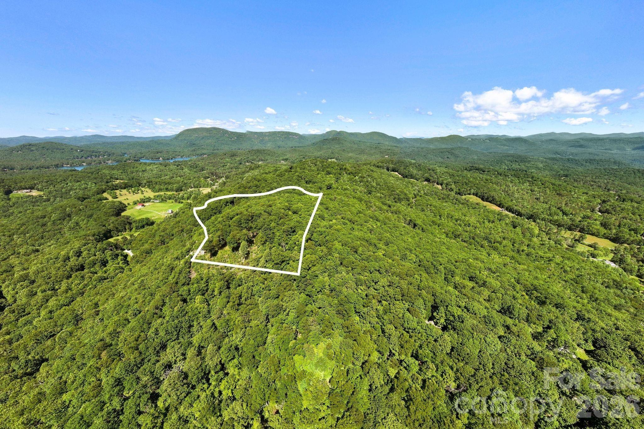 Approximate lot lines identify the homesite area while showcasing the property's elevated location and panoramic mountain backdrop. - 9999 Rocky Mountain Road, Lake Toxaway