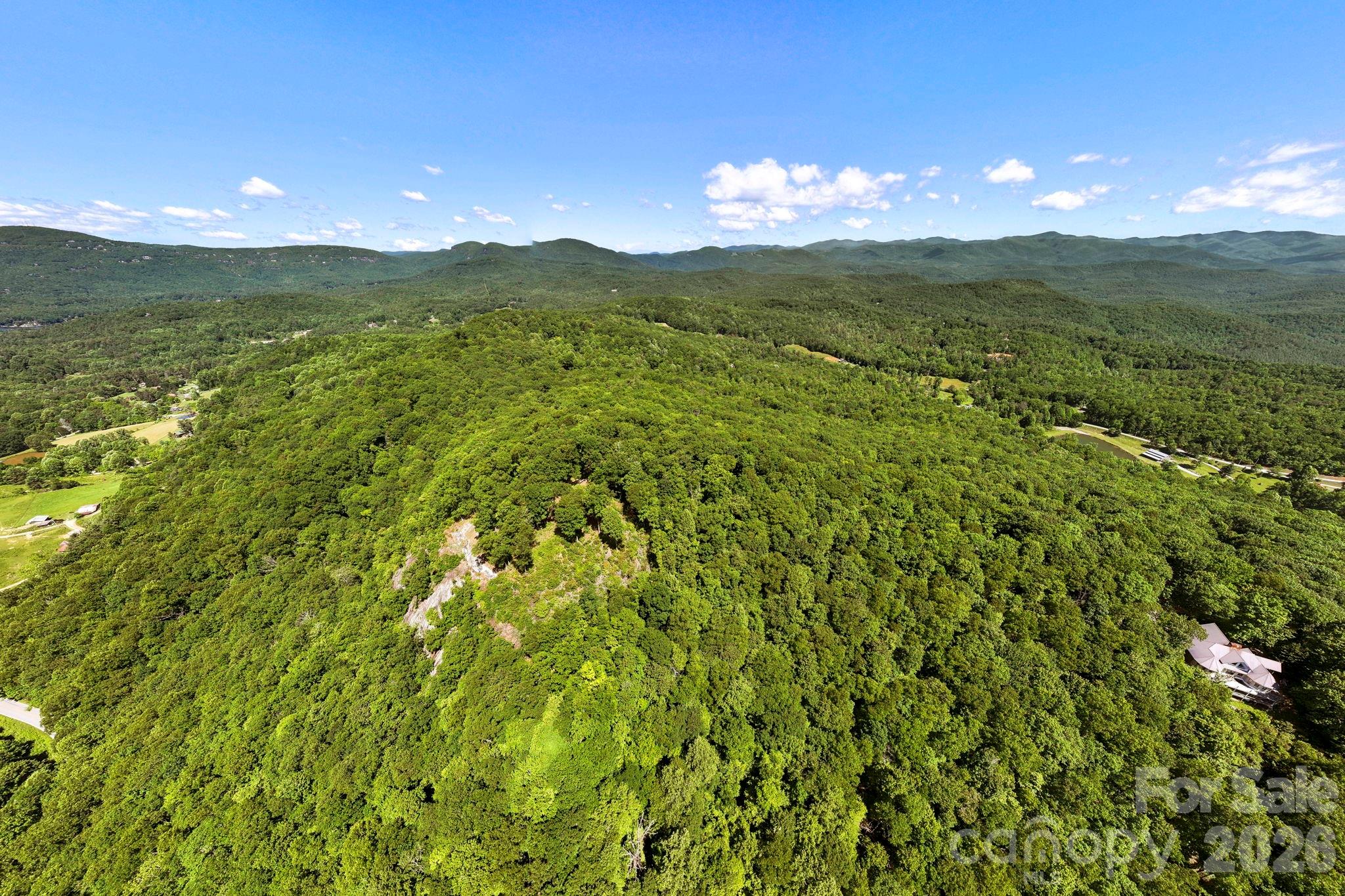 This aerial perspective illustrates the property's elevated position and exceptional long-range mountain vistas. - 9999 Rocky Mountain Road, Lake Toxaway