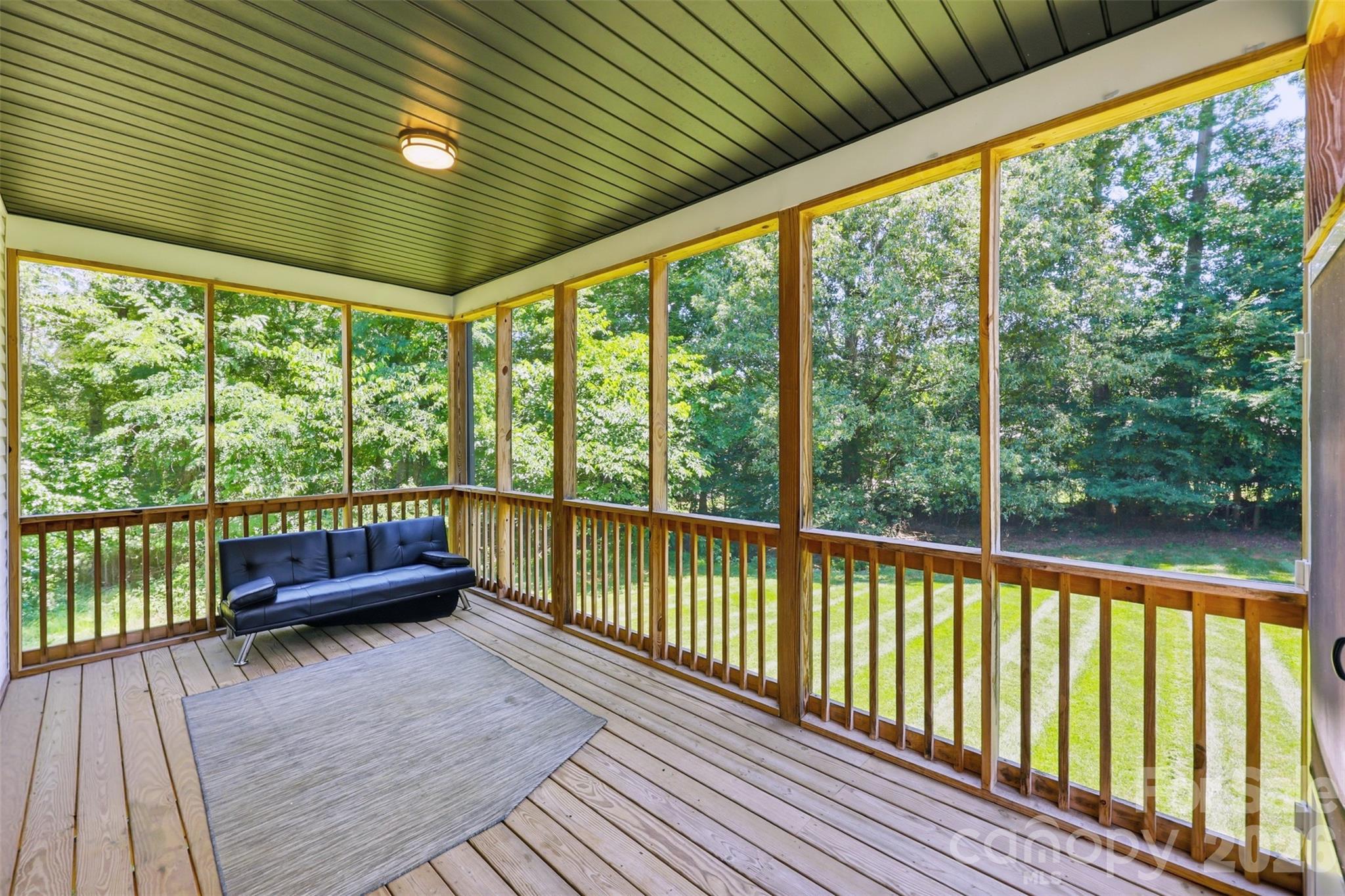 Covered, screened deck overlooks spacious backyard with wooded view. - 1298 Cole Avenue, Rock Hill