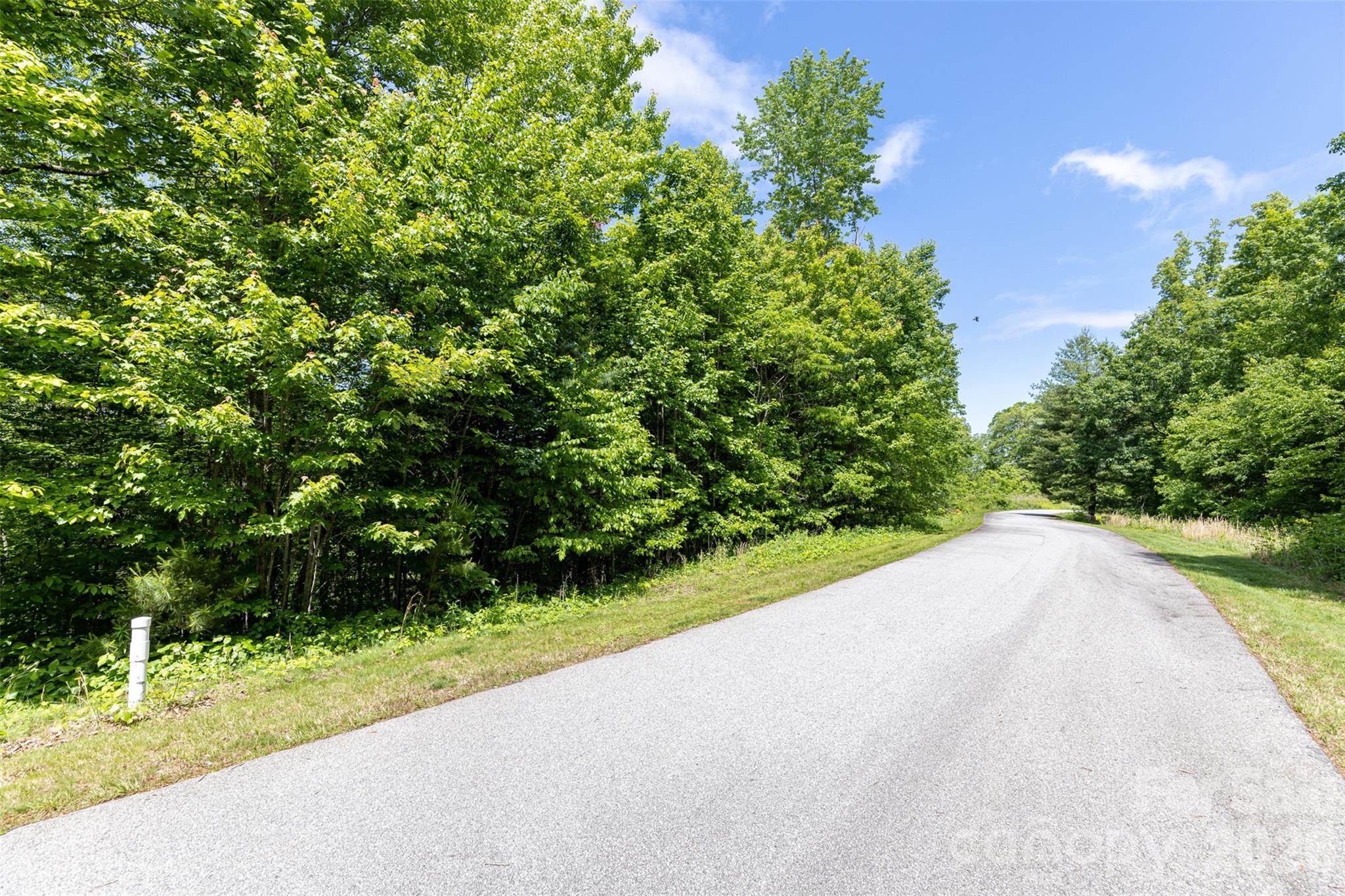 Community amenities include paved roads, city water and sewer, underground utilities, natural gas, scenic hiking trails, and the security of a gated entrance. - 92 Chimney Crest Drive, Asheville