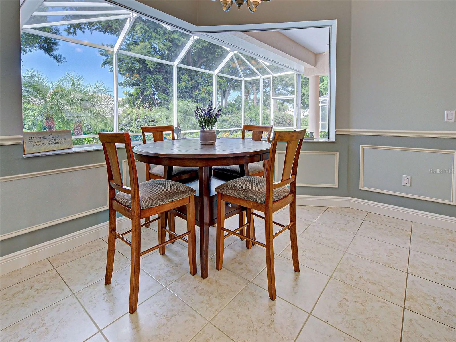 Dining Room With Aquarium Window to Lanai - 5017 BELLA TERRA DR, VENICE