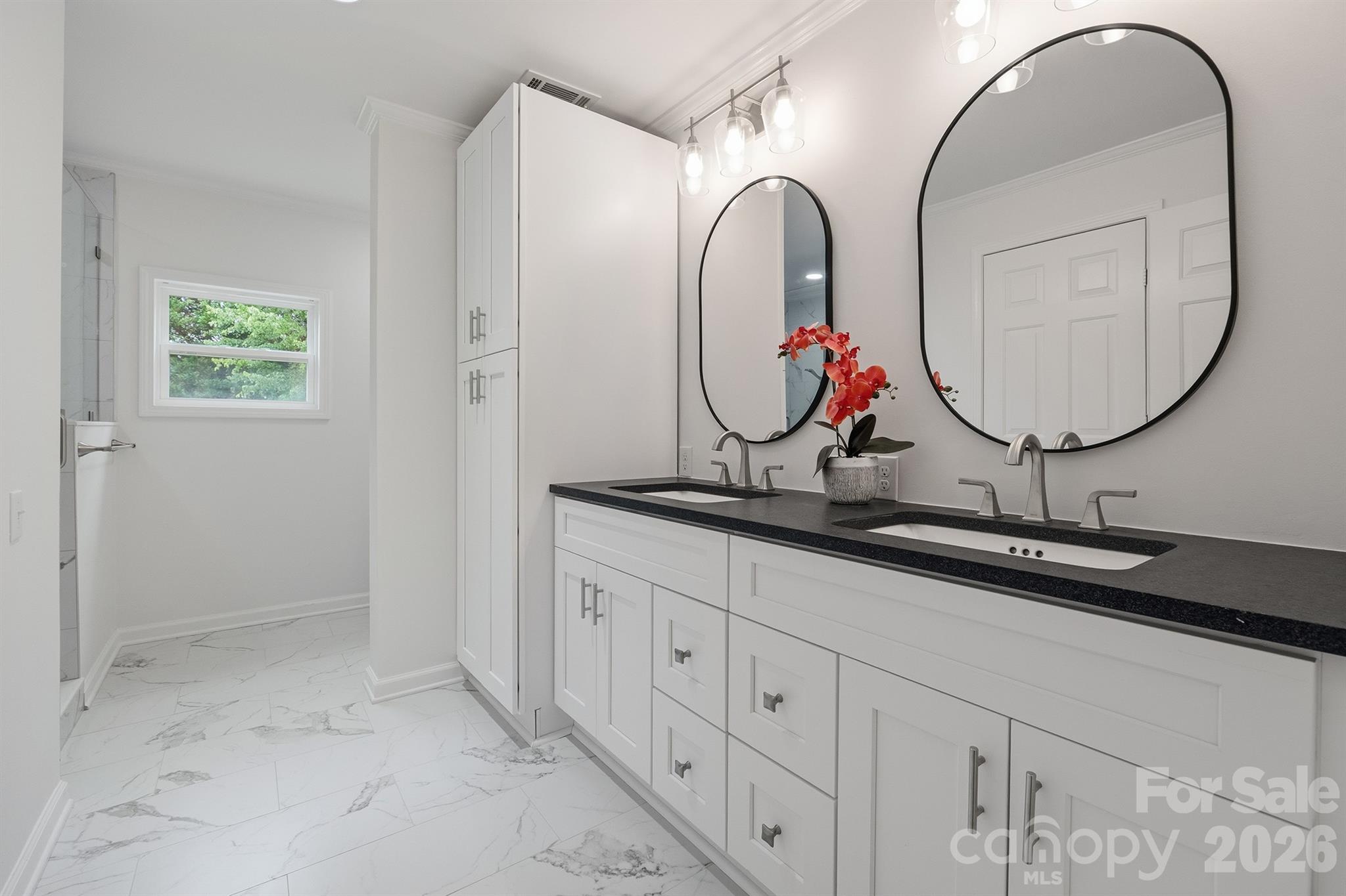Primary bath with leathered granite and double sinks - 7553 Katherine Drive, Denver