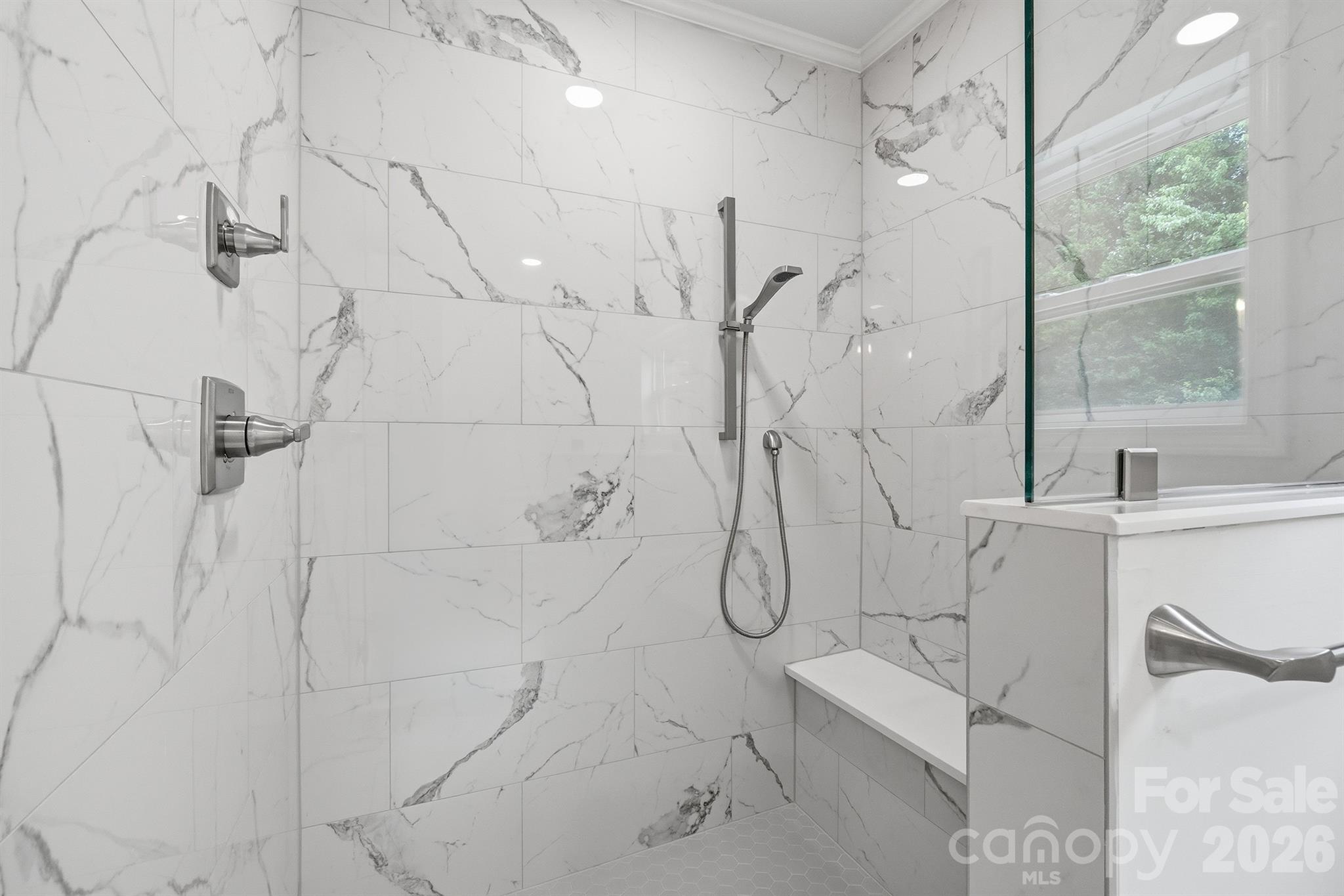 Luxury full tile shower with bench and multiple shower heads - 7553 Katherine Drive, Denver